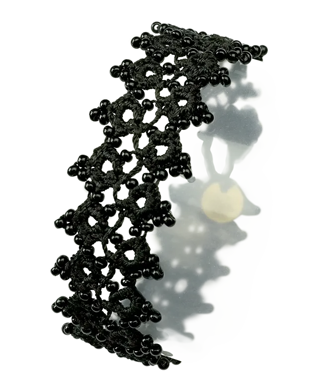 Pair of handmade lace fabric bracelets worn around a woman's wrist