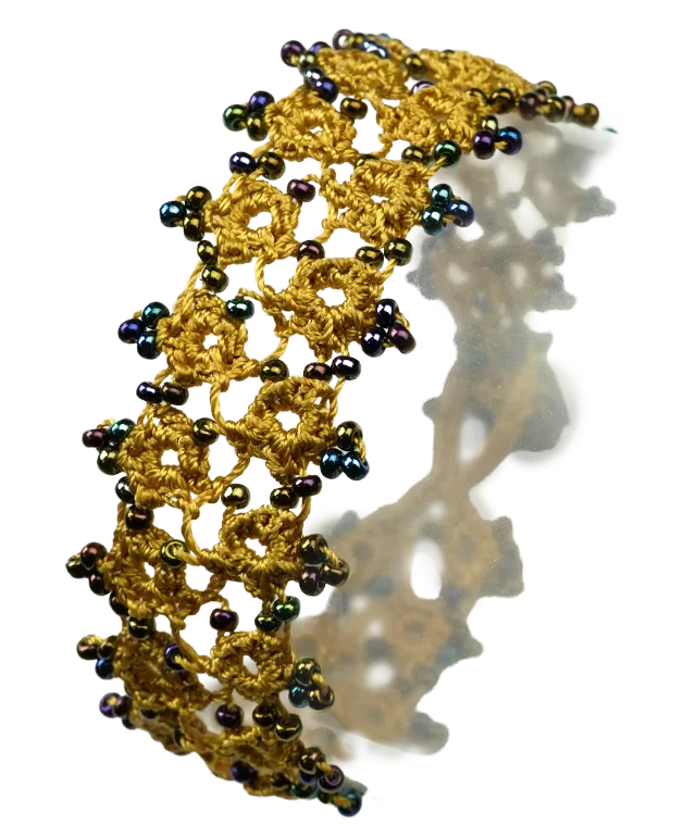 Handmade lace textile bracelet, Husnu, OYA collection, lichen green colour on a pebble