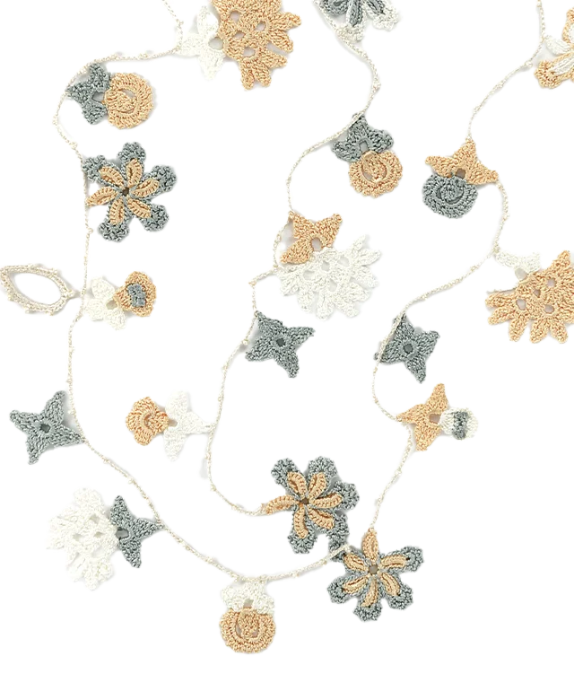 Kapadokya white lace necklace brushing against a woman's hair