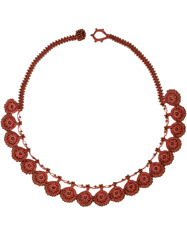 Matt copper-colored lace necklace worn by a person, close-up view