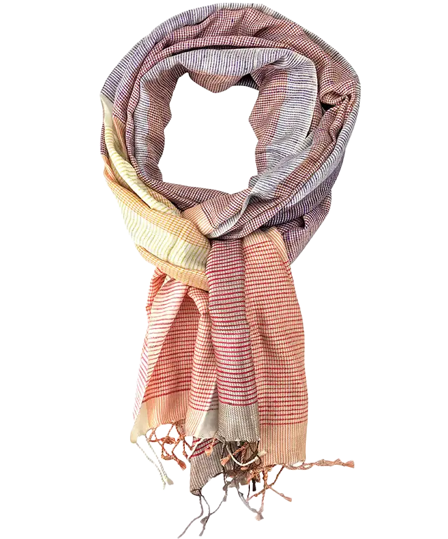 Red-orange Eri silk stole over a white outfit that blends in with the wall