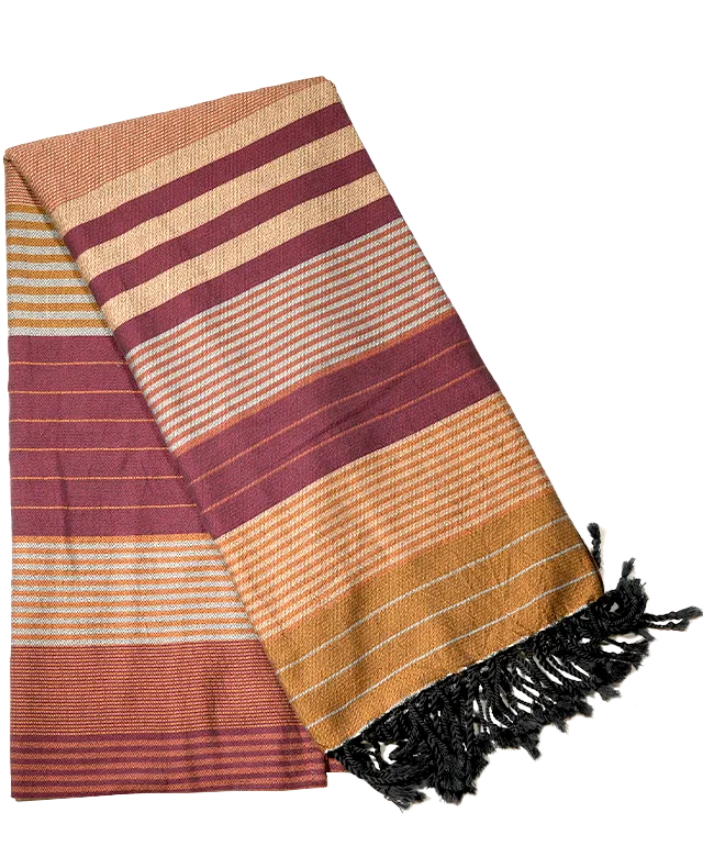 Arabesk-coloured fouta in organic cotton hanging from a wooden ladder, white wall