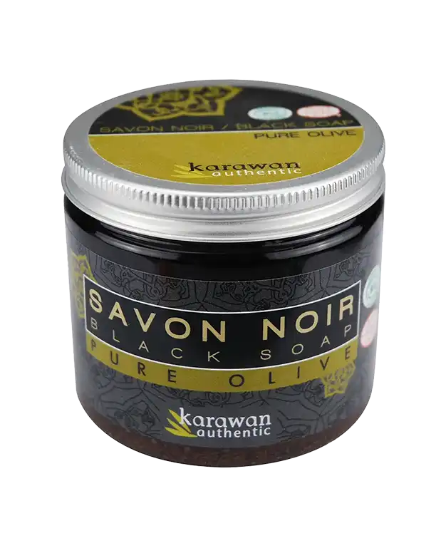 Pot of pure olive oil black soap on a black exfoliating kessa glove