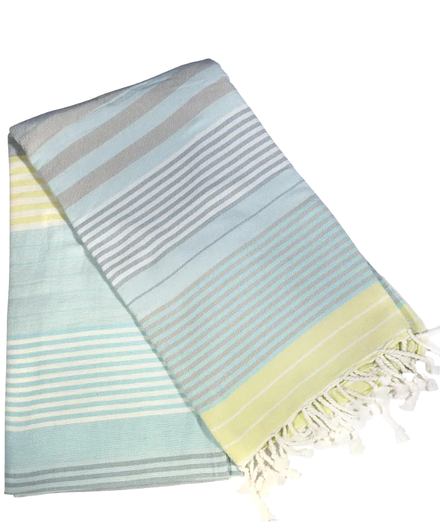 Fouta en coton bio coloris Sunny Lime, suspendu à un mur blanc, plateau en laiton doré Moon et sac posé sur une chaise