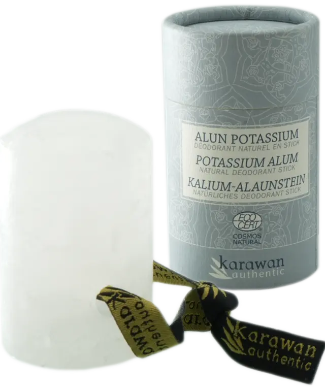 Alum stone stick, Cosmos natural certified, and its packaging on a brass dish