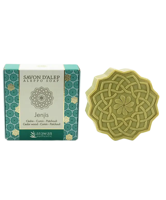 Jenjis scented Aleppo soap, in the shape of flowers and with a woody fragrance, next to its golden box