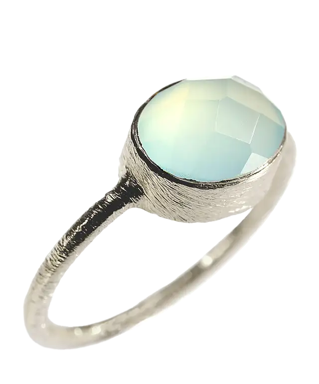 Woman wearing a silver and chalcedony ‘Drop’ ring by Karawan