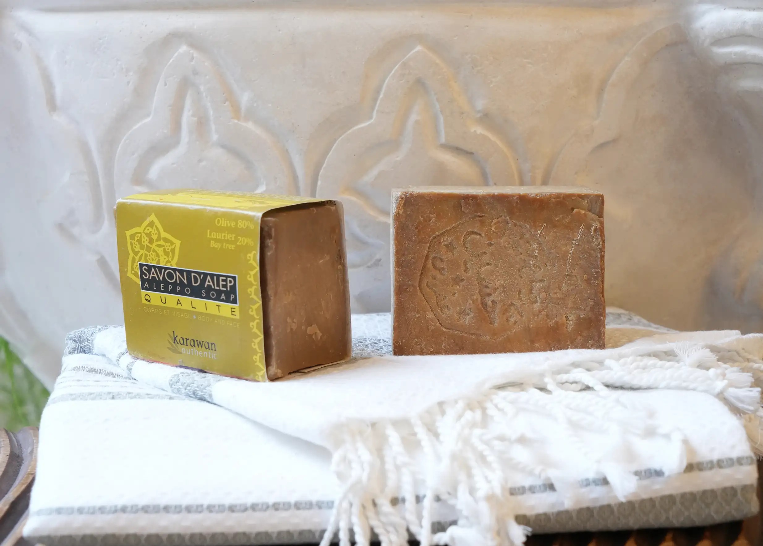 20% laurel oil Aleppo soap in band and another bar soap on a fouta