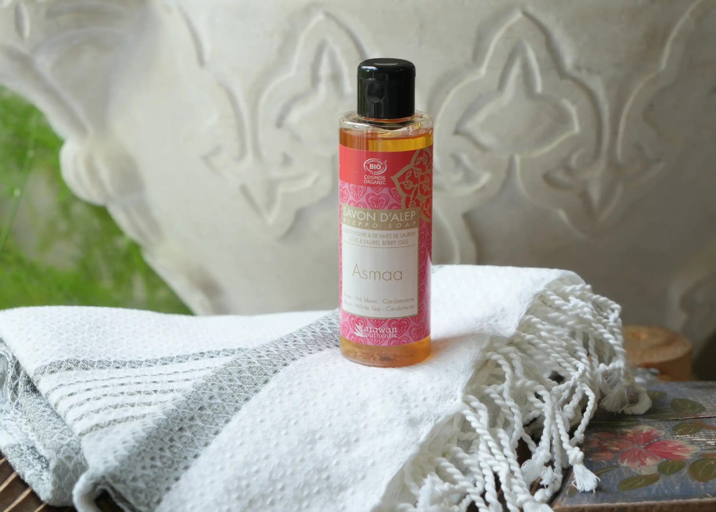 Bottle of Asmaa liquid Aleppo soap on a fouta Bottle of Asmaa liquid Aleppo soap on a fouta