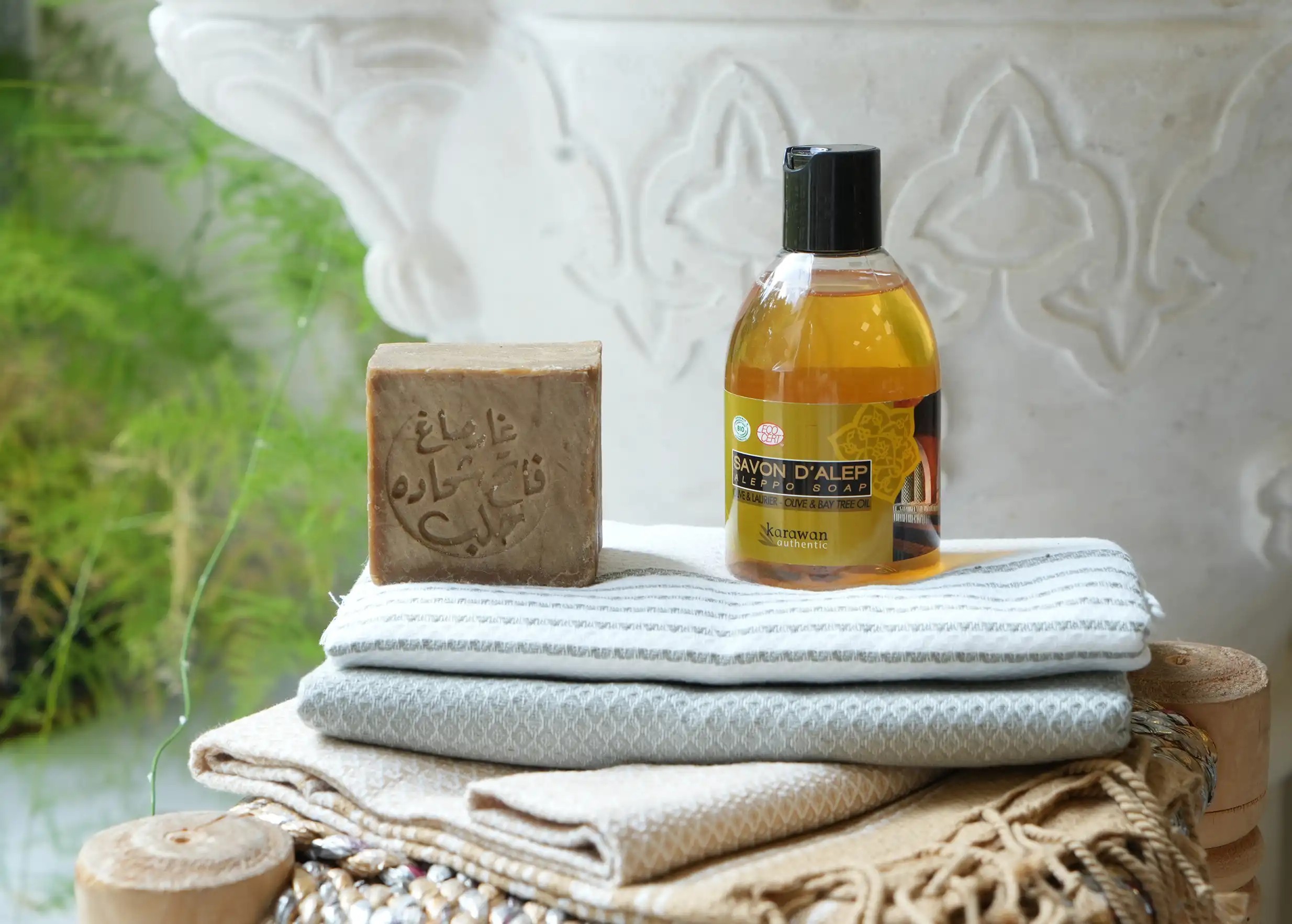 Traditional, authentic Aleppo soap and liquid soap in a bottle Traditional, authentic Aleppo soap and liquid soap in a bottle