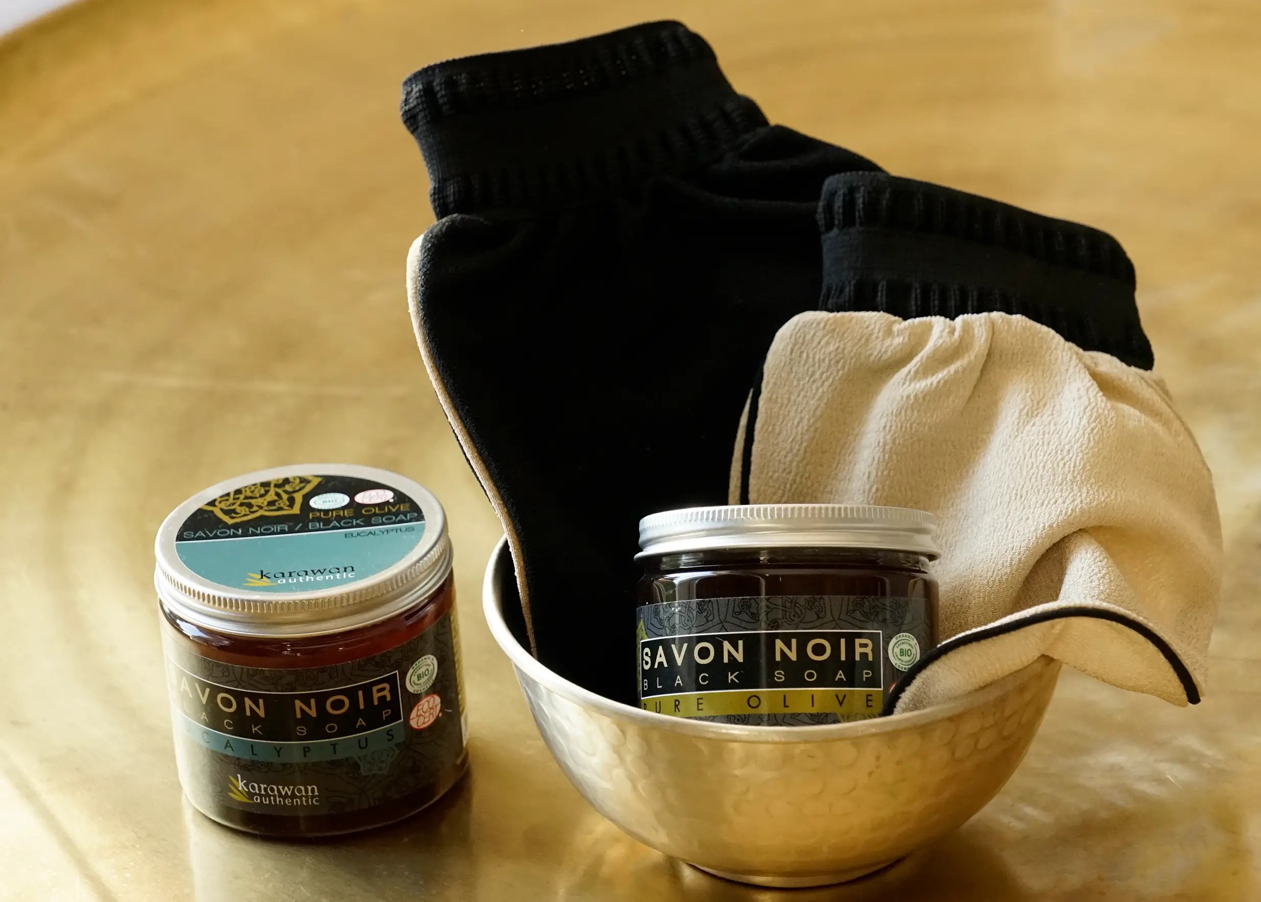 Jars of pure olive oil and eucalyptus soap, kessa gloves and brass bowl