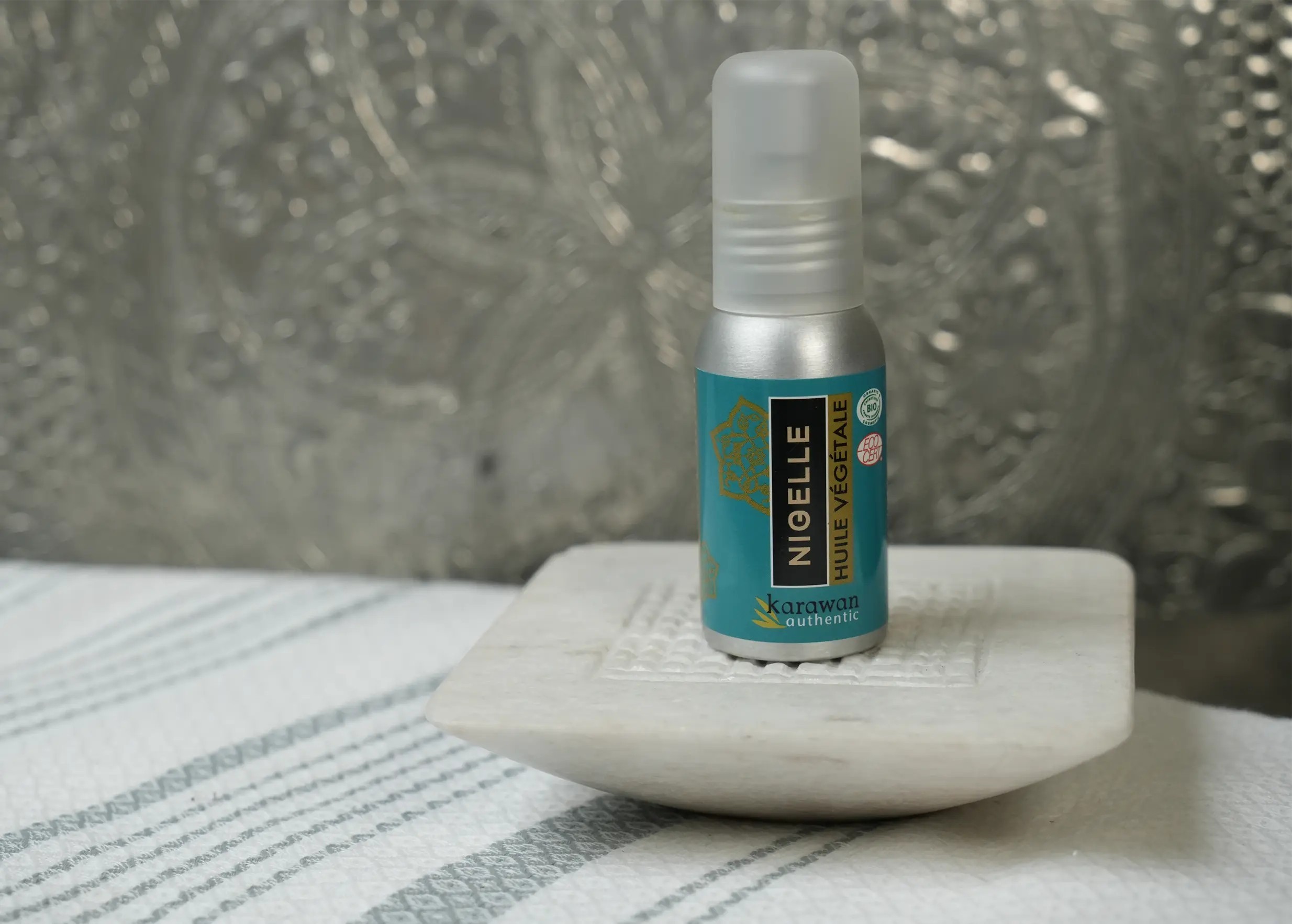 50ml bottle of organic nigelle oil, also known as black cumin oil, on a stand