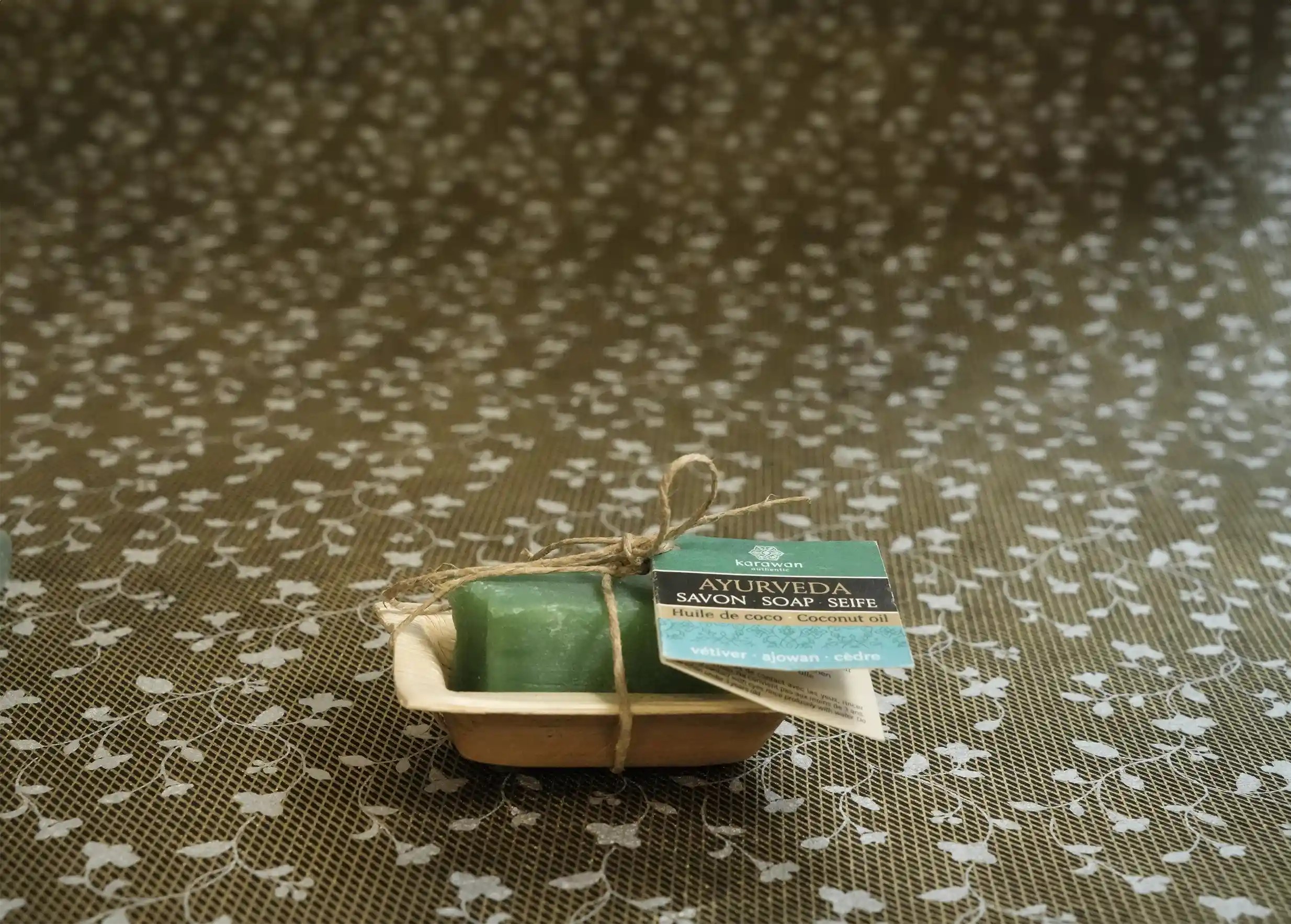 Karawan Ayurvedic soap with vetiver, ecopackaging, white leaf pattern background