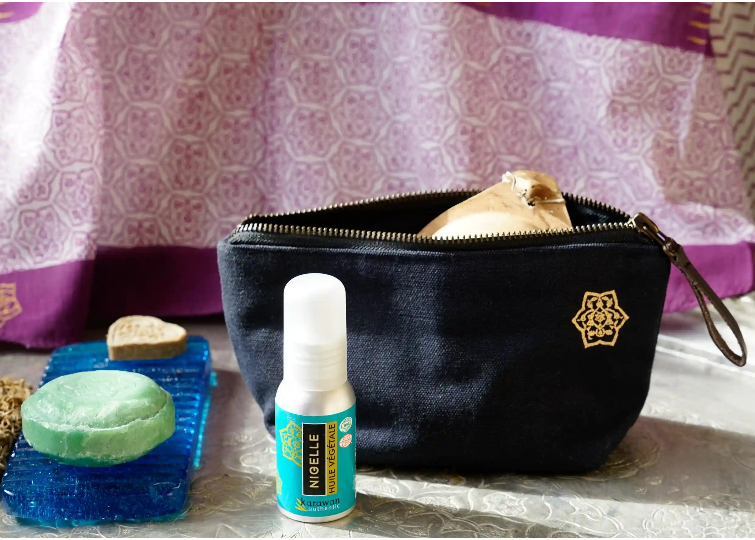 Shade cotton toilet bag, soap on a glass stand and black cumin oil