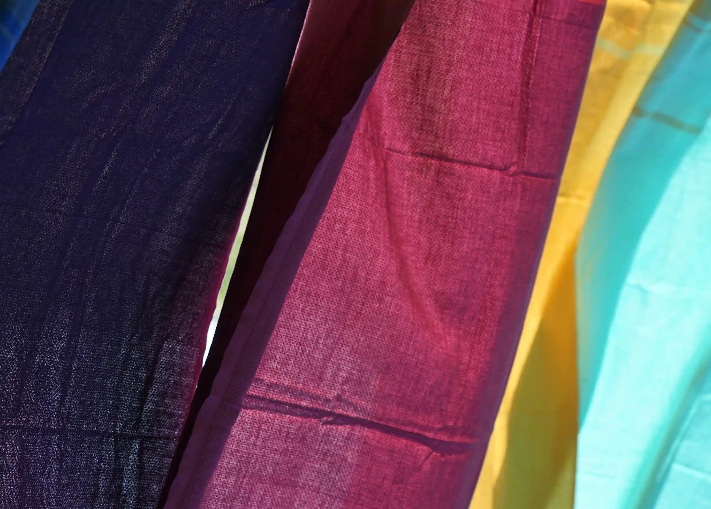 Close-up of foutas in different colours, including purple, red, yellow and turquoise