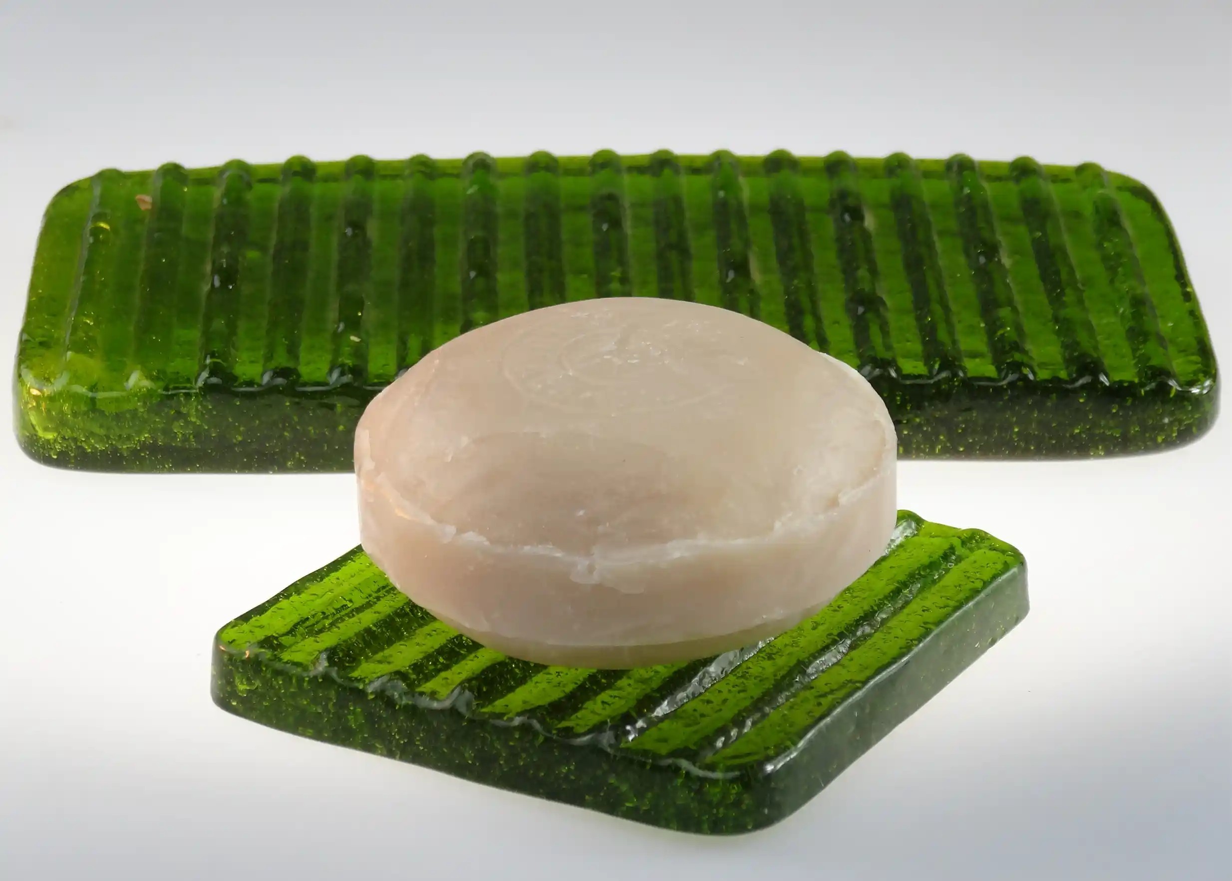 Ice recycled glass soap dish with an ayurvedic soap on a white background
