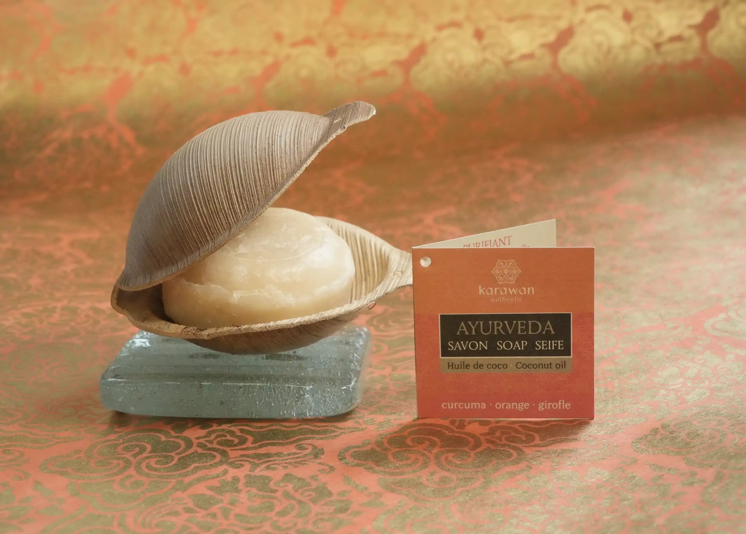 100g Ayurvedic turmeric soap in a vegetable shell, on a glass soap dish, with cardboard label