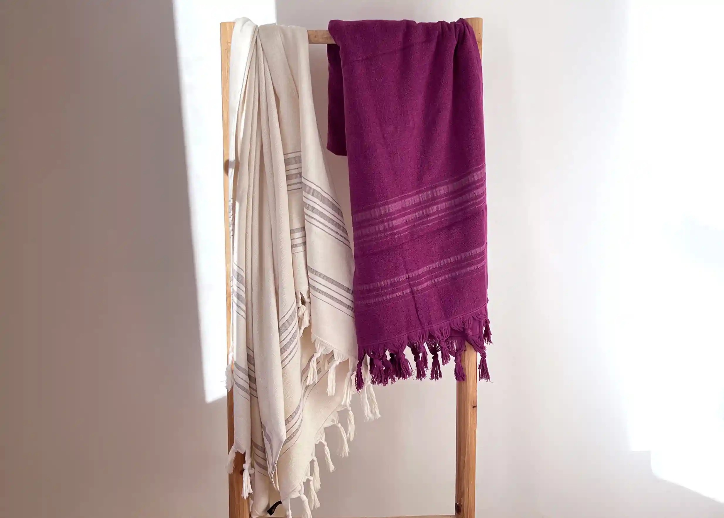 Amethyst and moonstone coloured foutas by Karawan hanged on a ladder