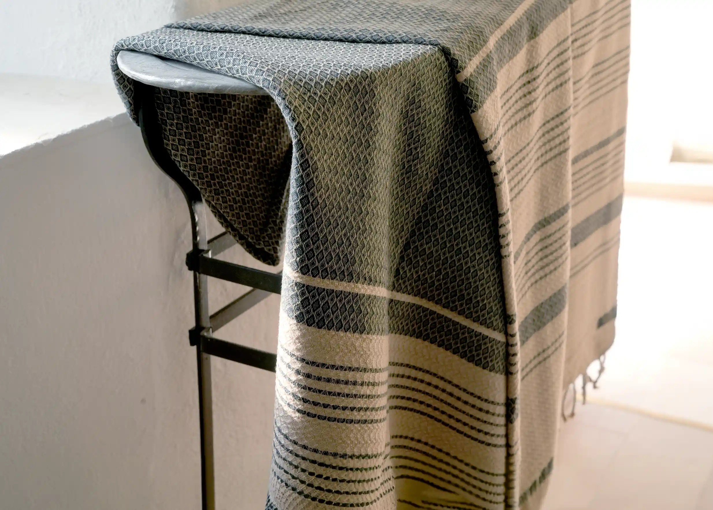 Fouta en coton biologique Sand, coloris cendre, par Karawan authentic, légèrement repliée, des tons foncés et sableux