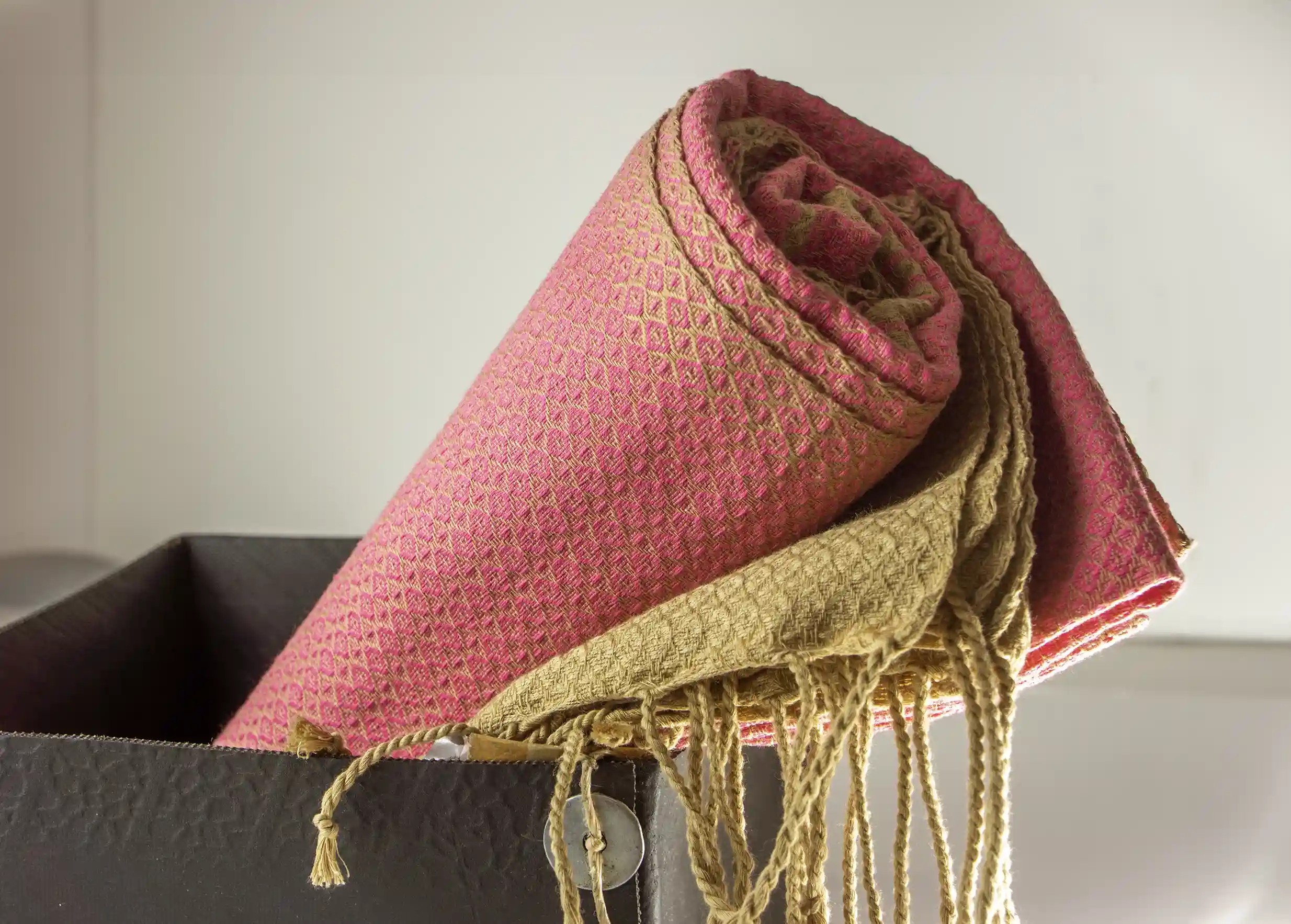Indian pink coloured organic cotton fouta, wrapped in a recycled tyre pot
