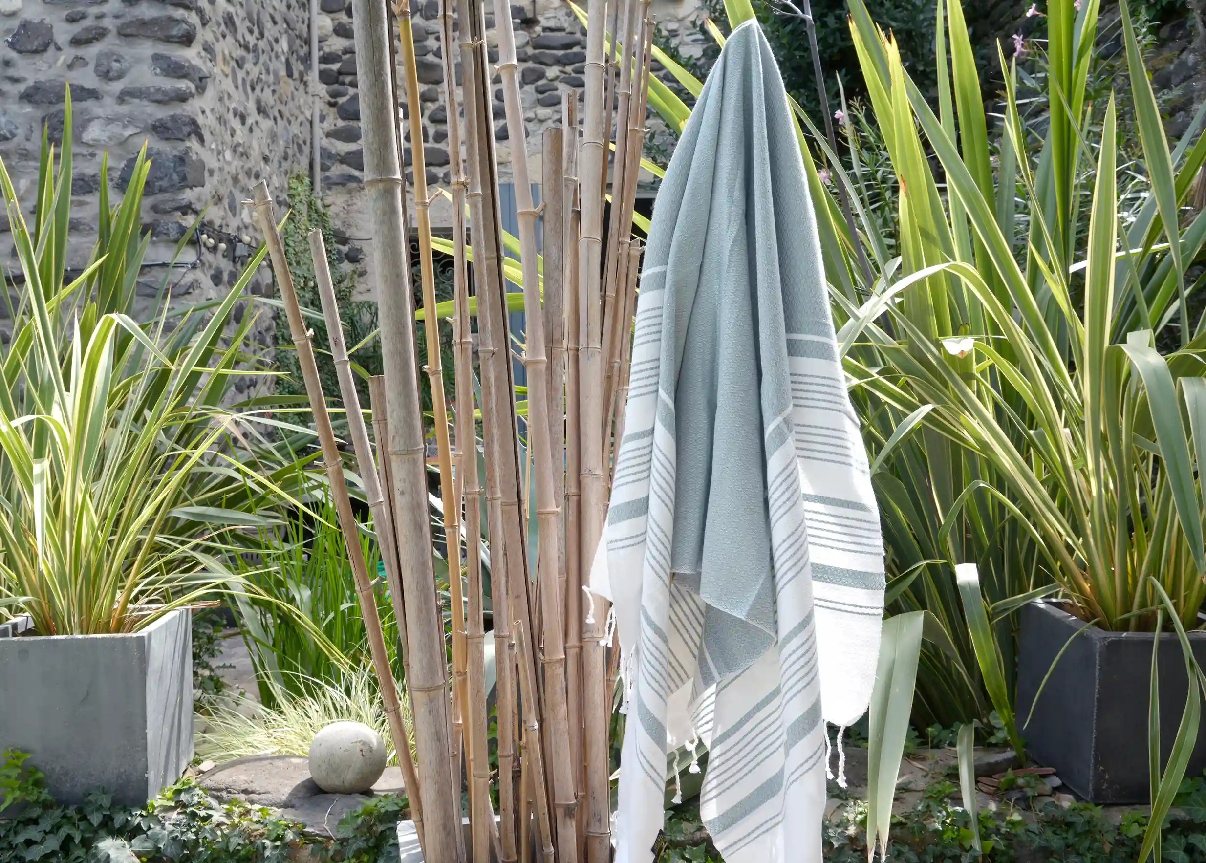 Mirage-coloured fouta, close-up, hanging from a bamboo stem