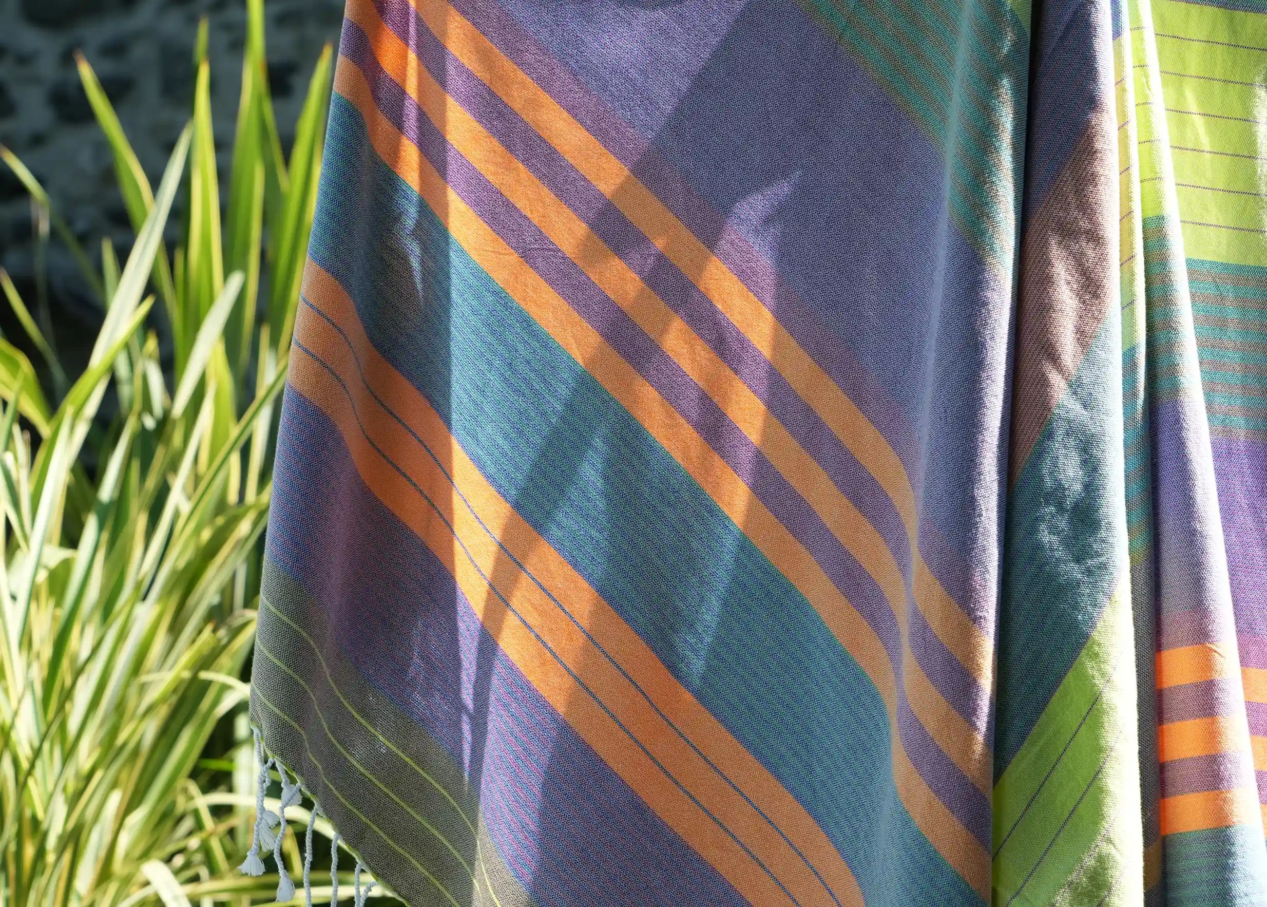 Purple sun coloured organic cotton fouta seen up close, highlighting its bright, warm colours