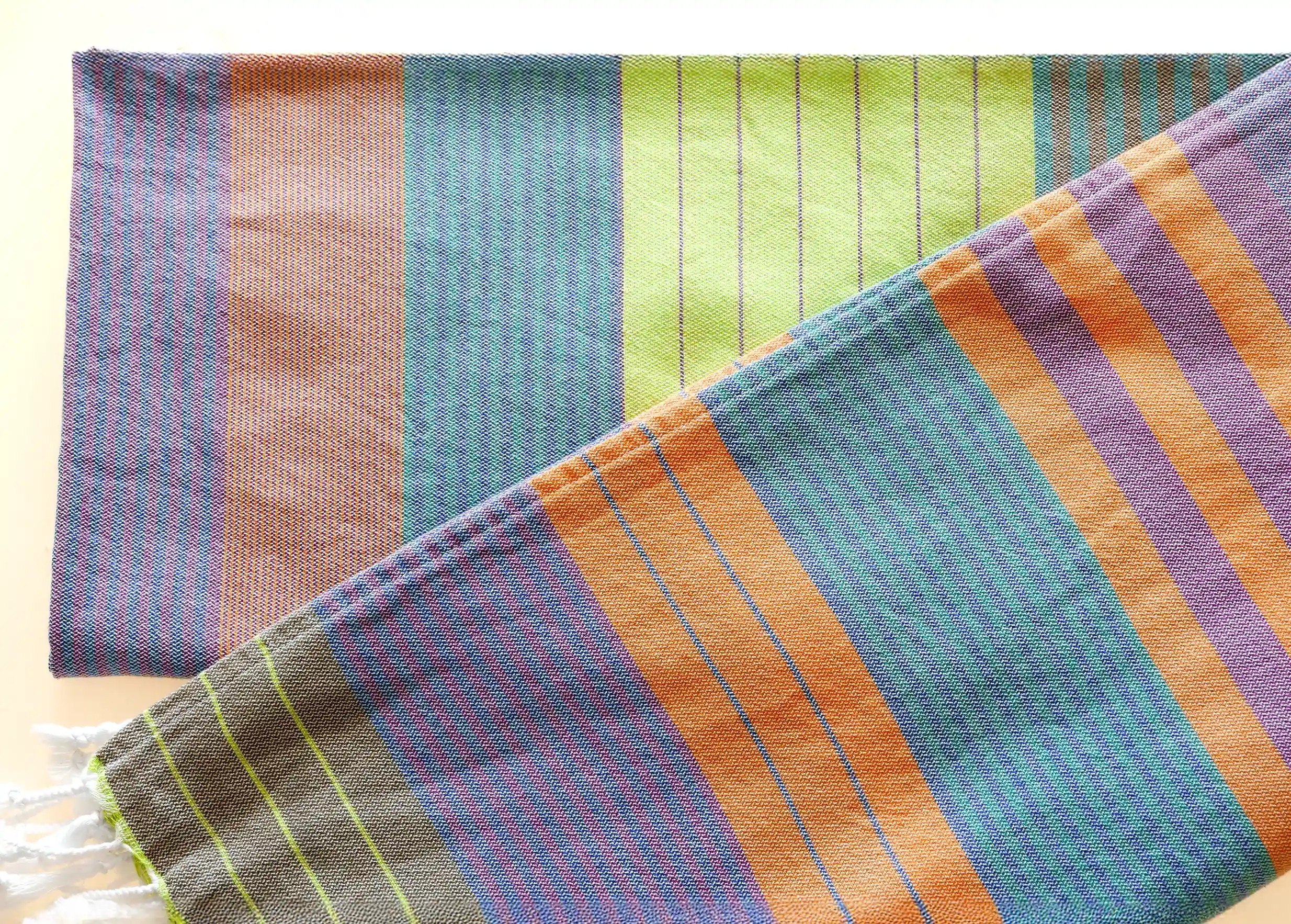 Zoom in on the details of the purple sun coloured organic cotton fouta from the Sud collection