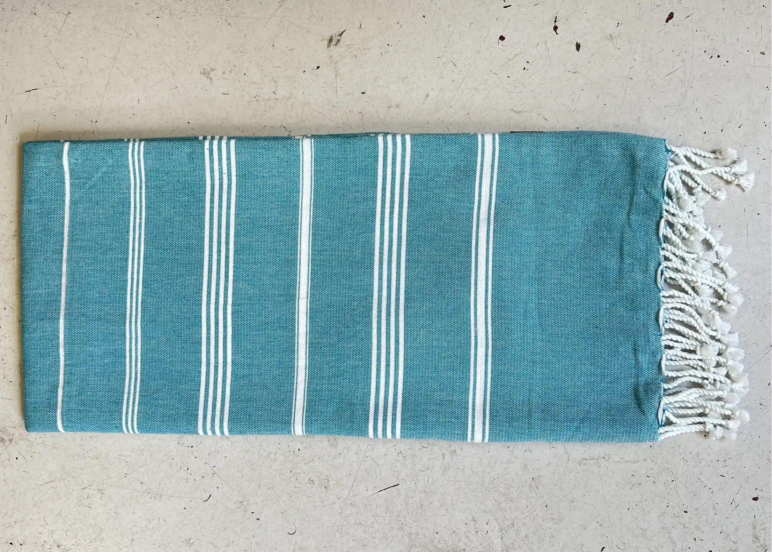 Atoll blue fouta in organic cotton on the ground Atoll blue fouta in organic cotton on the ground