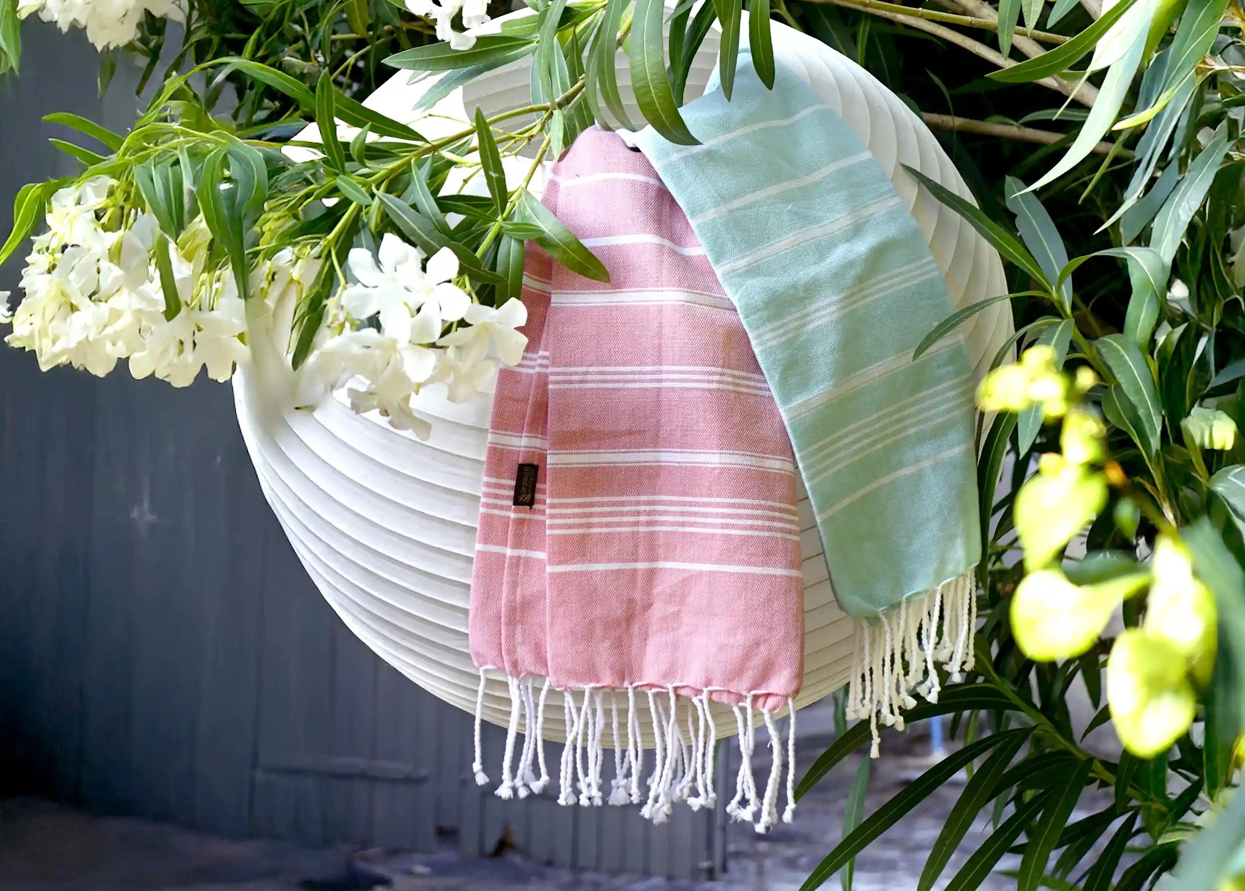 Two organic cotton foutas, mint and coral colors, with white stripes Two organic cotton foutas, mint and coral colors, with white stripes