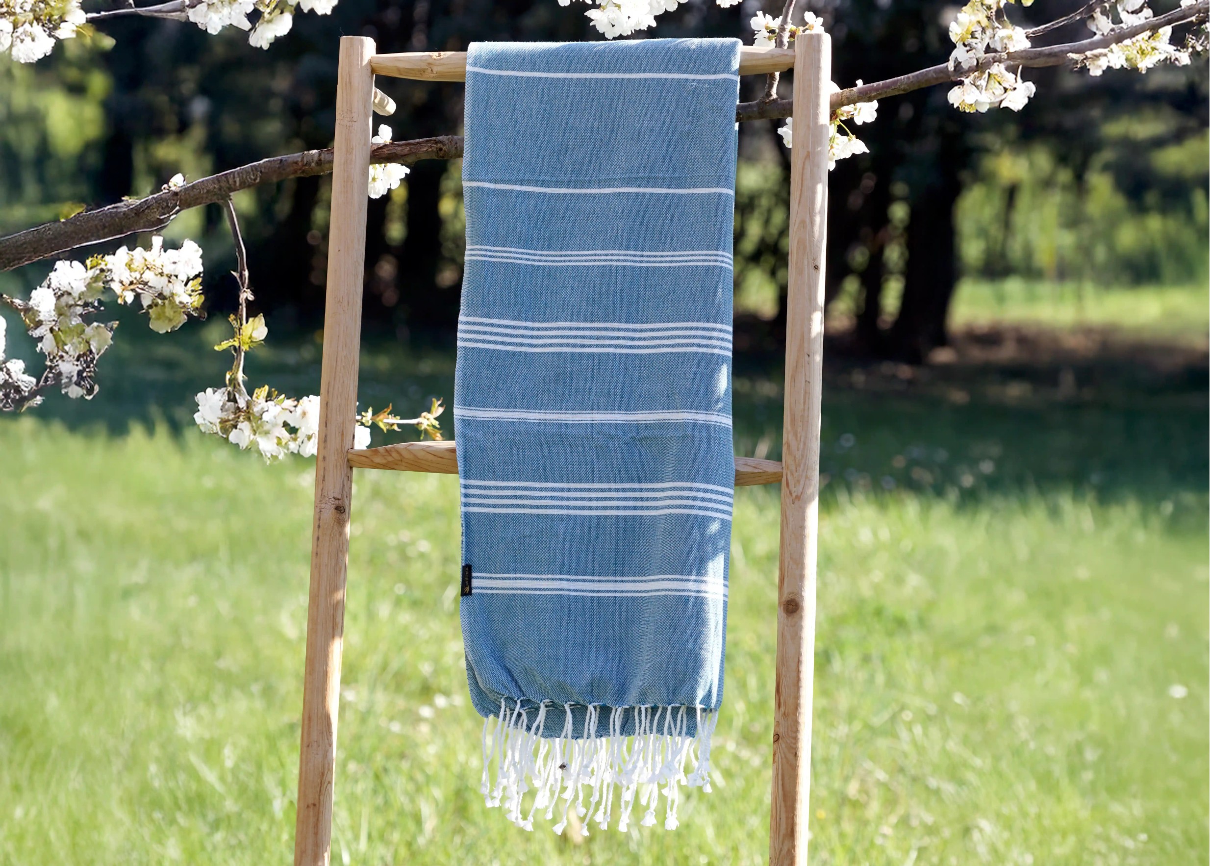 Fouta en coton bio océan de la gamme Hammam, suspendue en extérieur Fouta en coton bio océan de la gamme Hammam, suspendue en extérieur