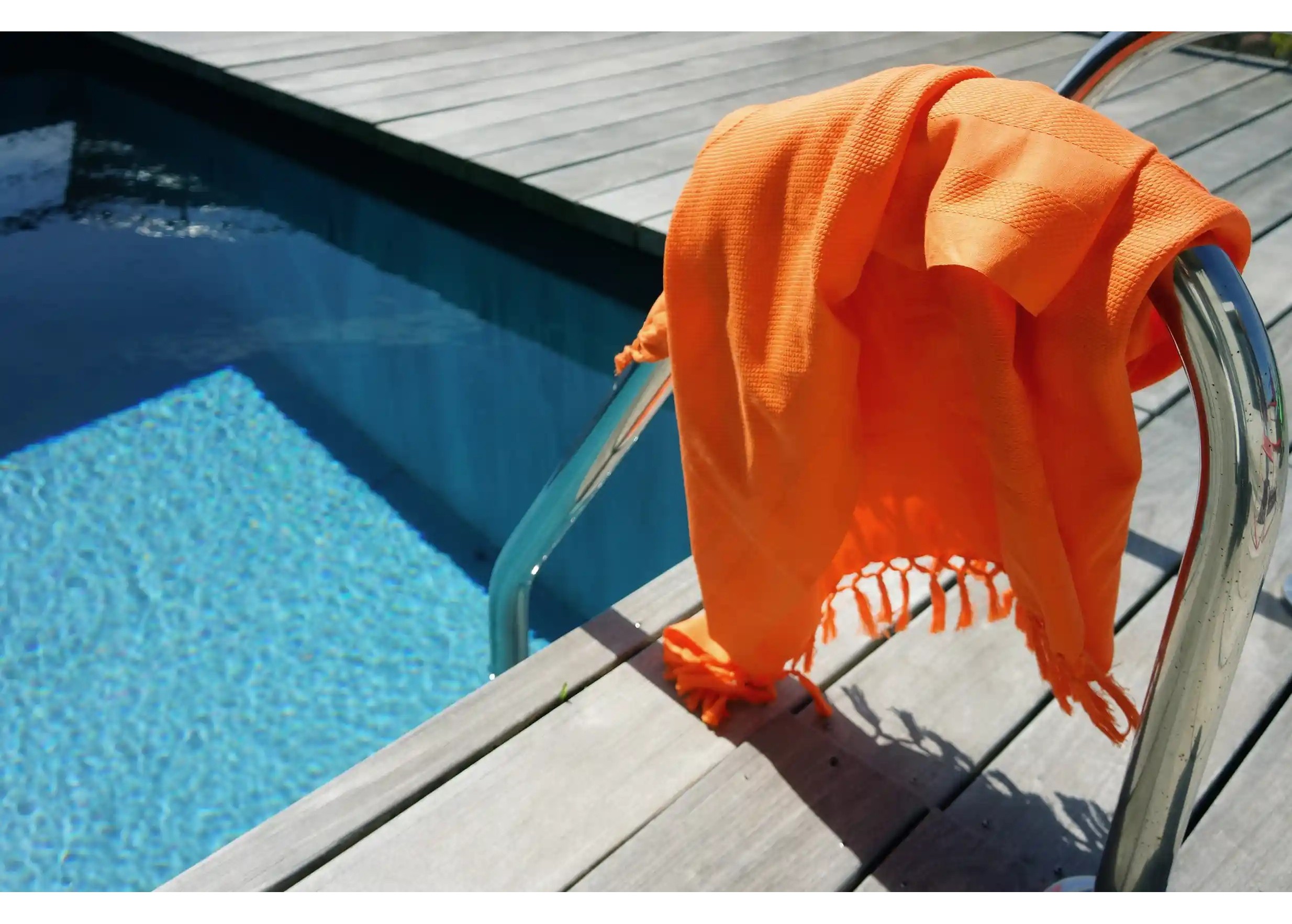 Organic cotton Fouta Curcuma by Karawan near a swimming pool
