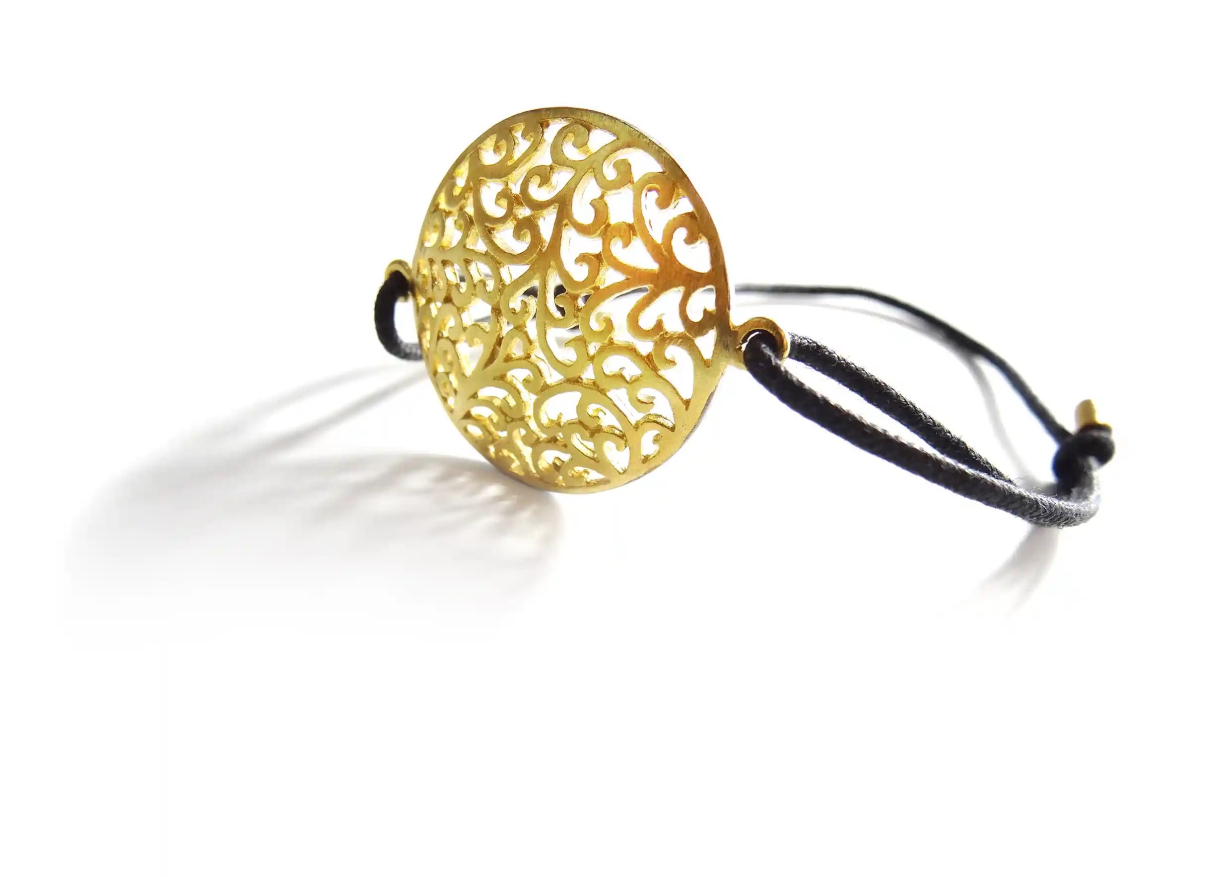 Gilded-plated brass bracelet from the Secret Garden range with T-shaped clasp, featuring a medallion surrounded by a gold frame.