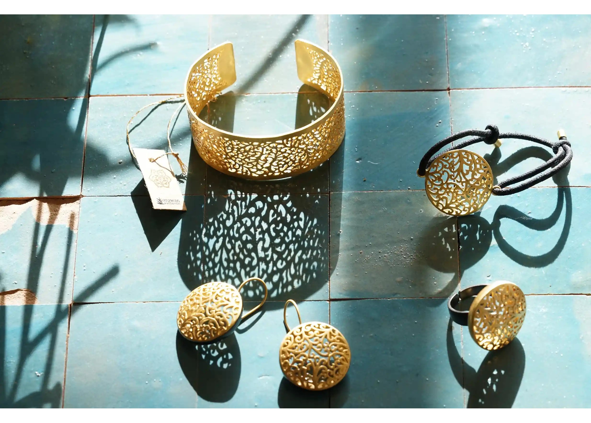 Collection of gilded-plated brass jewellery including bracelets, rings and earrings