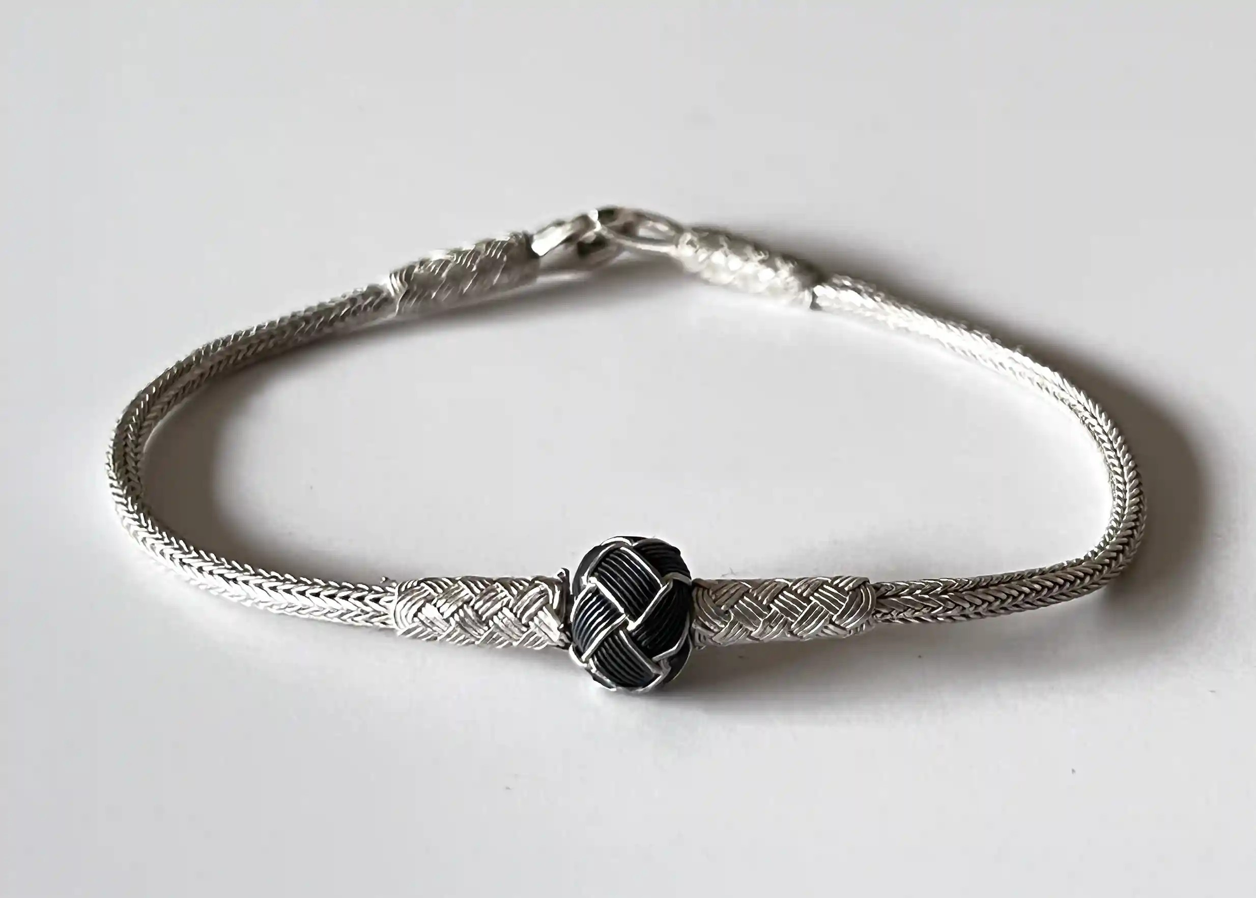 Silver and oxidised silver bracelet from the Kokaz jewellery collection, on a white background