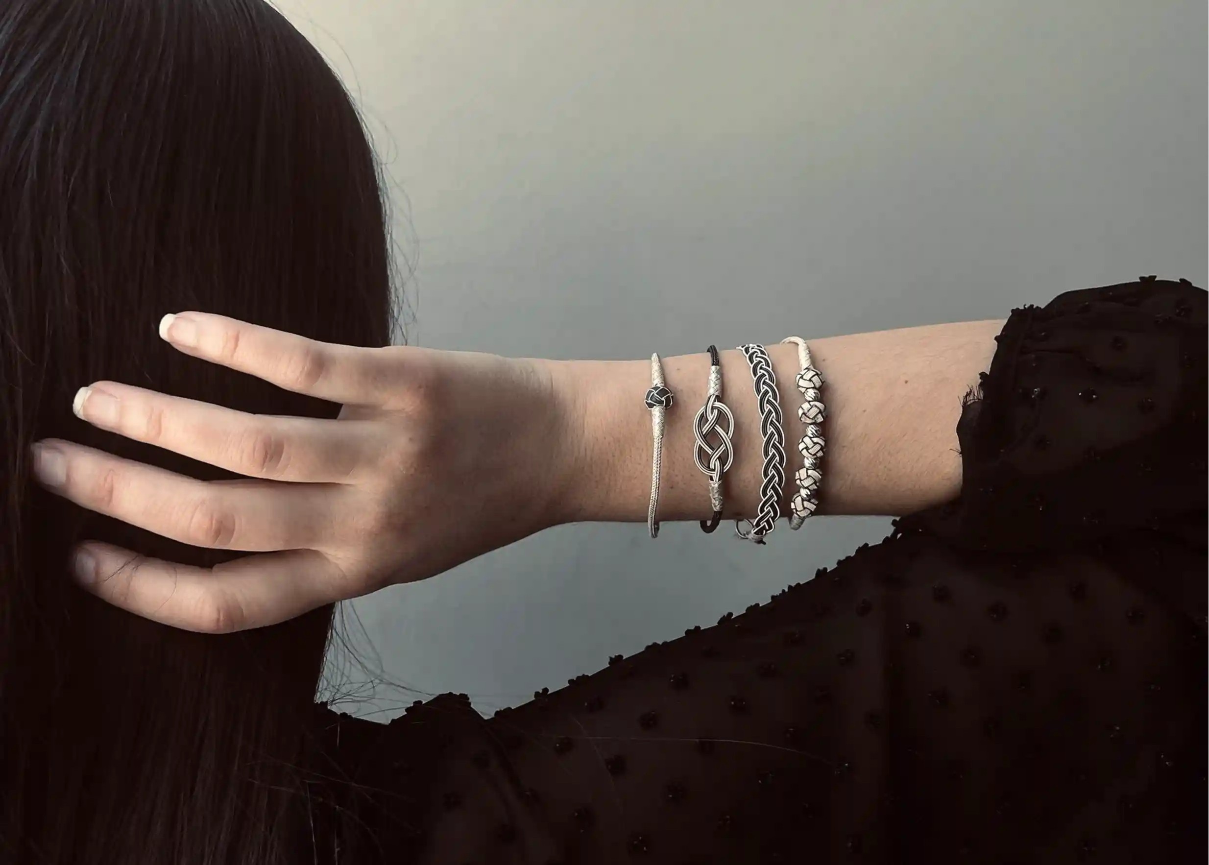 Woman wearing a set of bracelets from the KOKAZ collection, ‘Infinity’ model