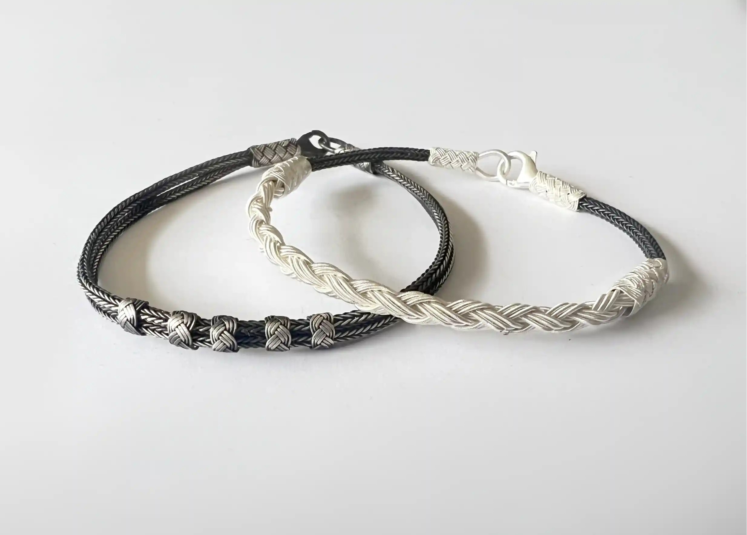 2 silver bracelets from the Kokaz jewellery collection, on a white background