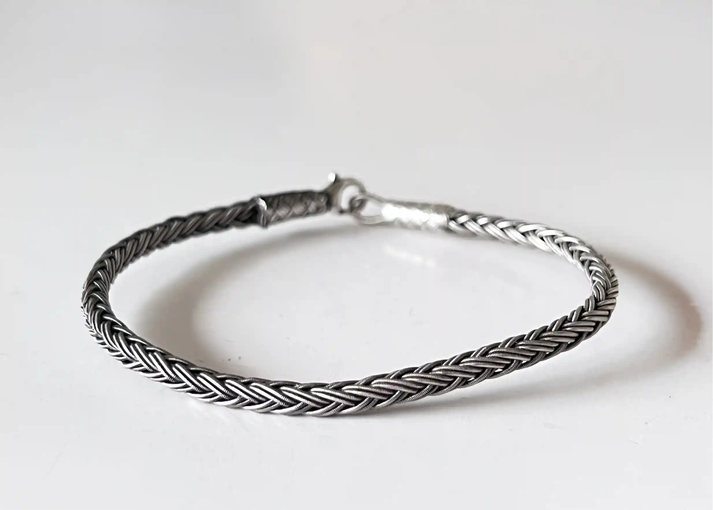 Silver bracelet from the Kokaz jewellery collection, round braid, with engraved Karawan authentic medal