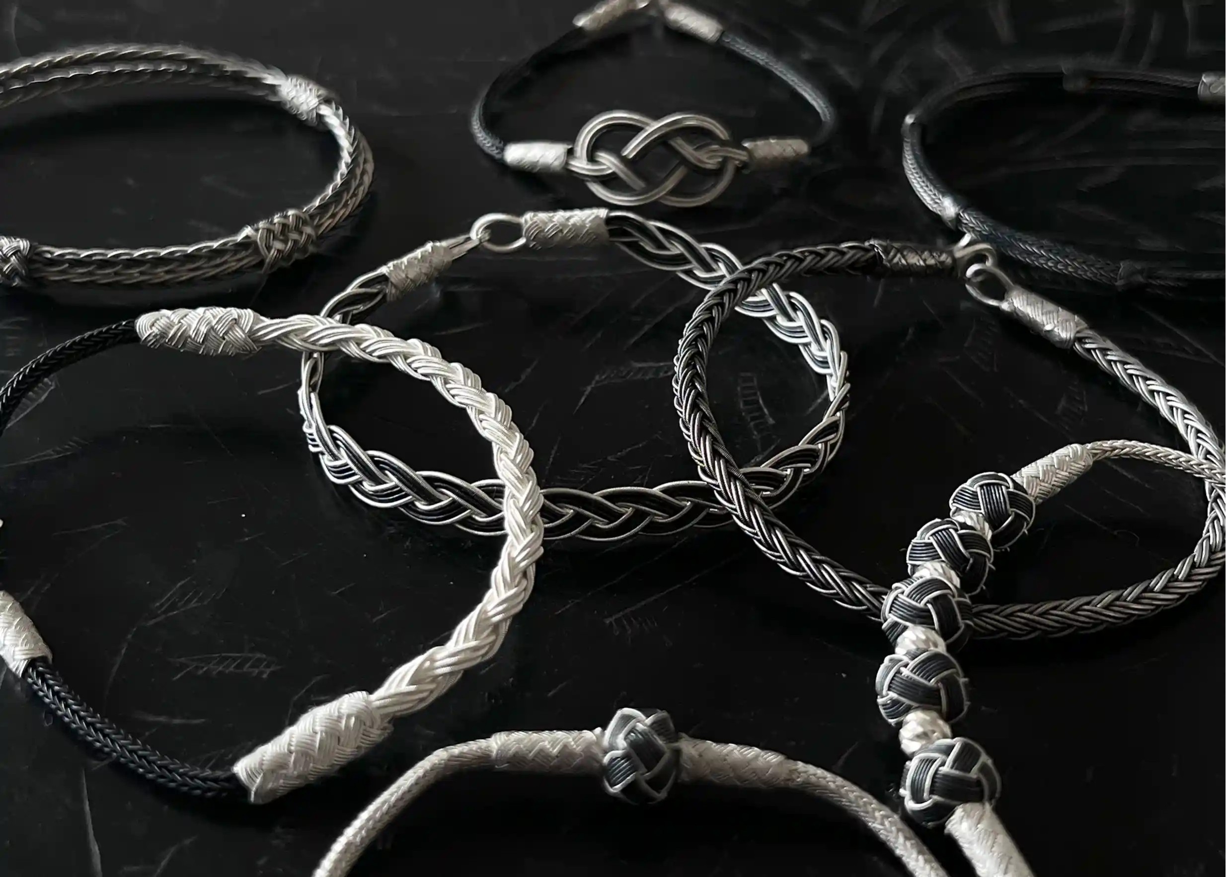 Set of bracelets from the Kokaz jewellery collection, placed on a black surface