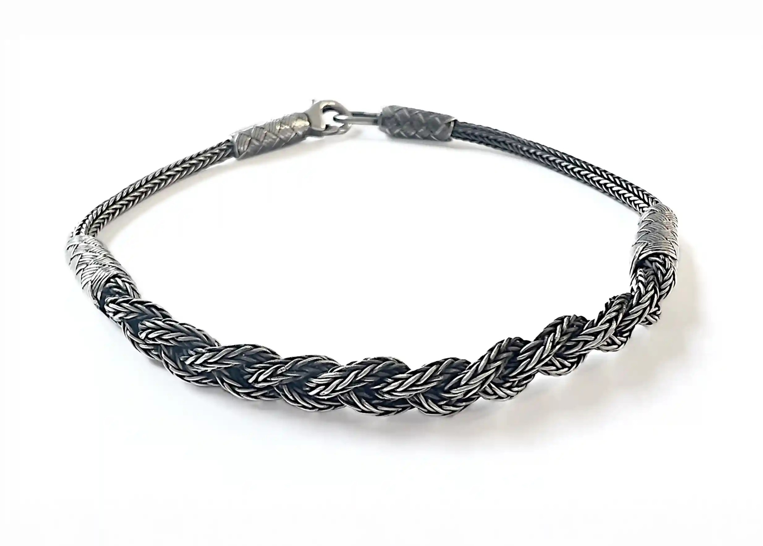 Silver bracelet from the Kokaz jewellery collection, braided chain, set on a white surface