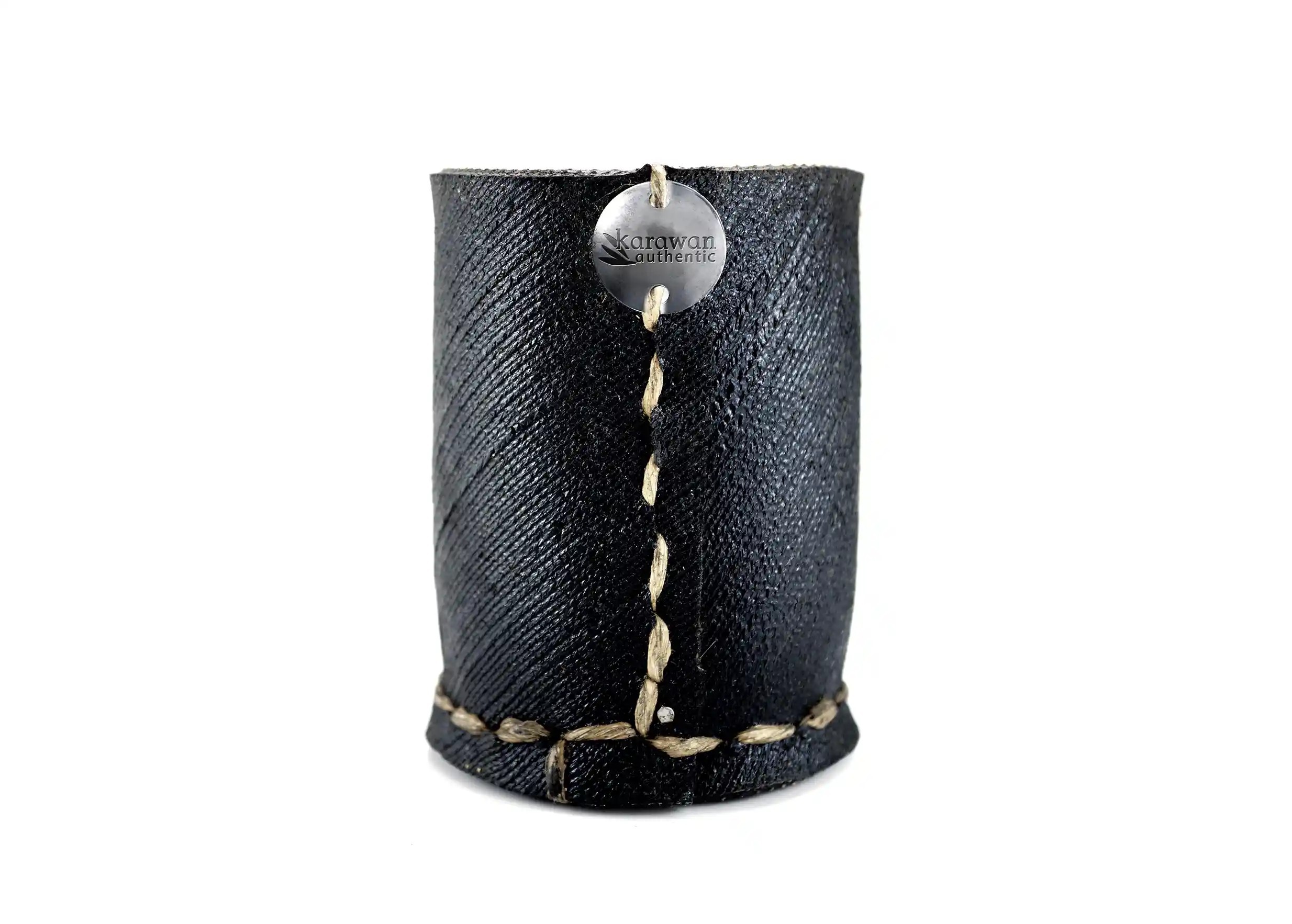 Small straight pot in recycled tyres, Karawan engraved metal button, picture taken on a white background