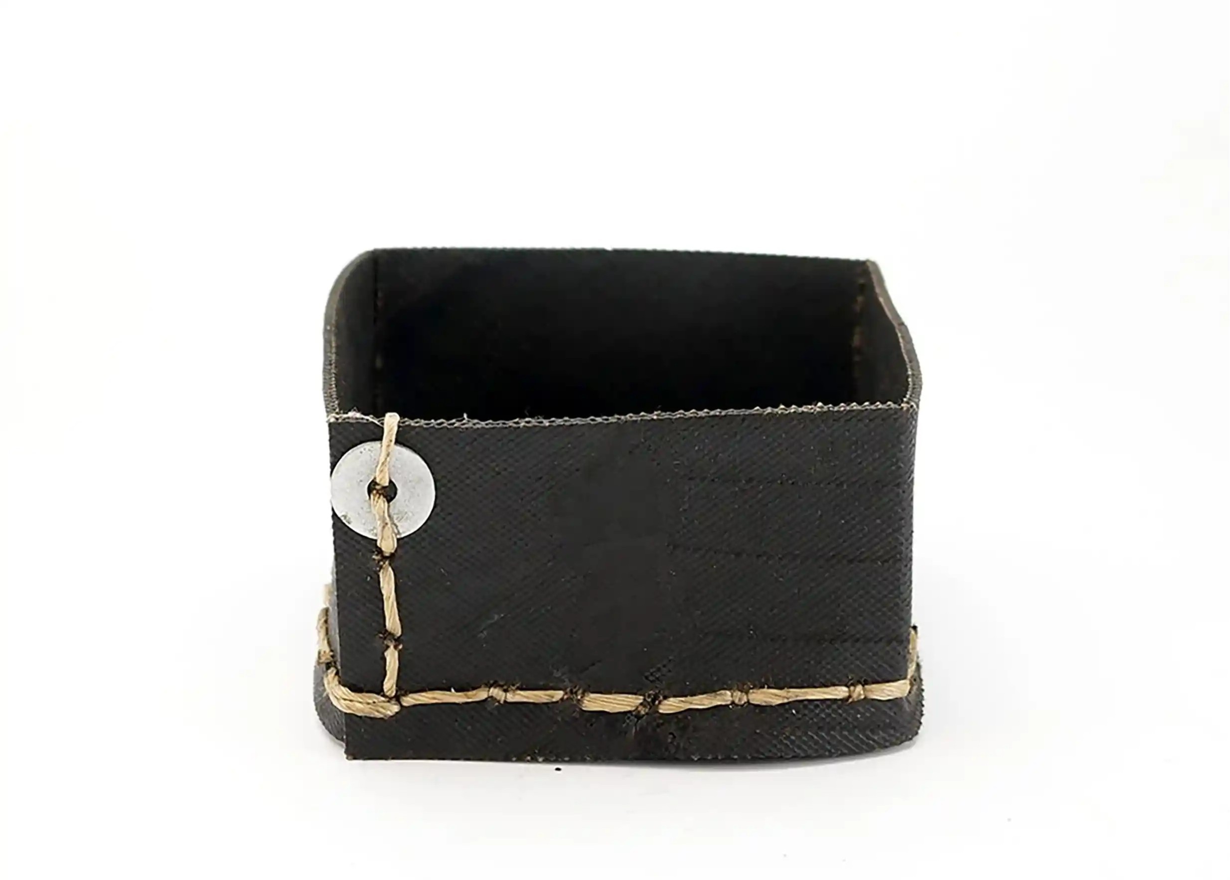 Small square box in black recycled tyres, with hand-crafted borders, on a white background