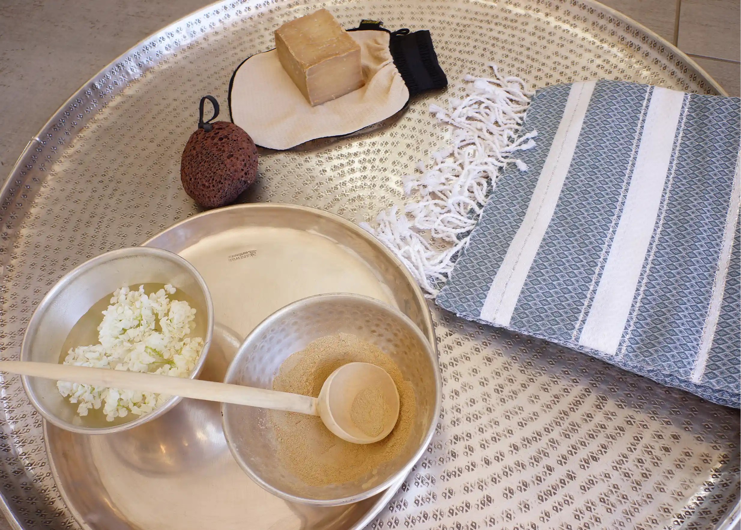 Set of brass bowls, brass dishes and brass trays, Aleppo soap with olive oil and pumice stone