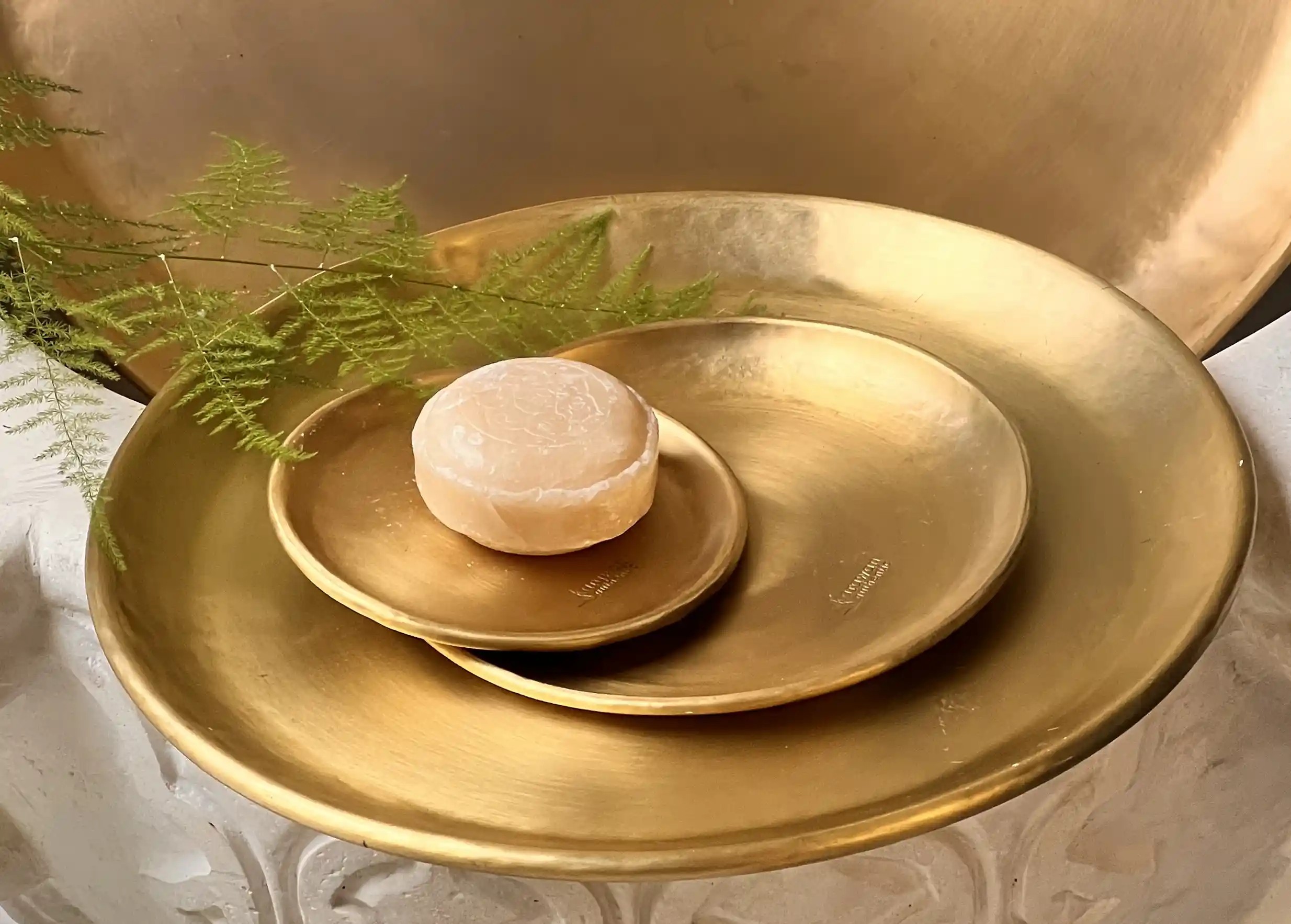 Set of gilded brass dishes by Karawan, with decorative foliage.