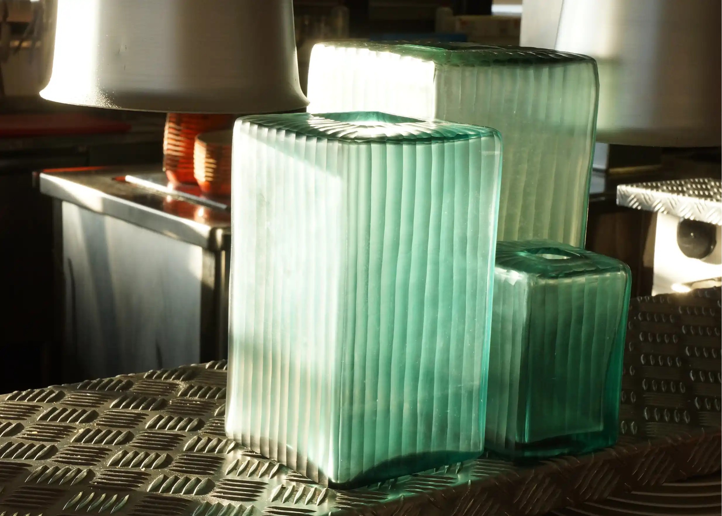 Rectangular blown and recycled glass vases with an aqua blue tint and translucent appearance