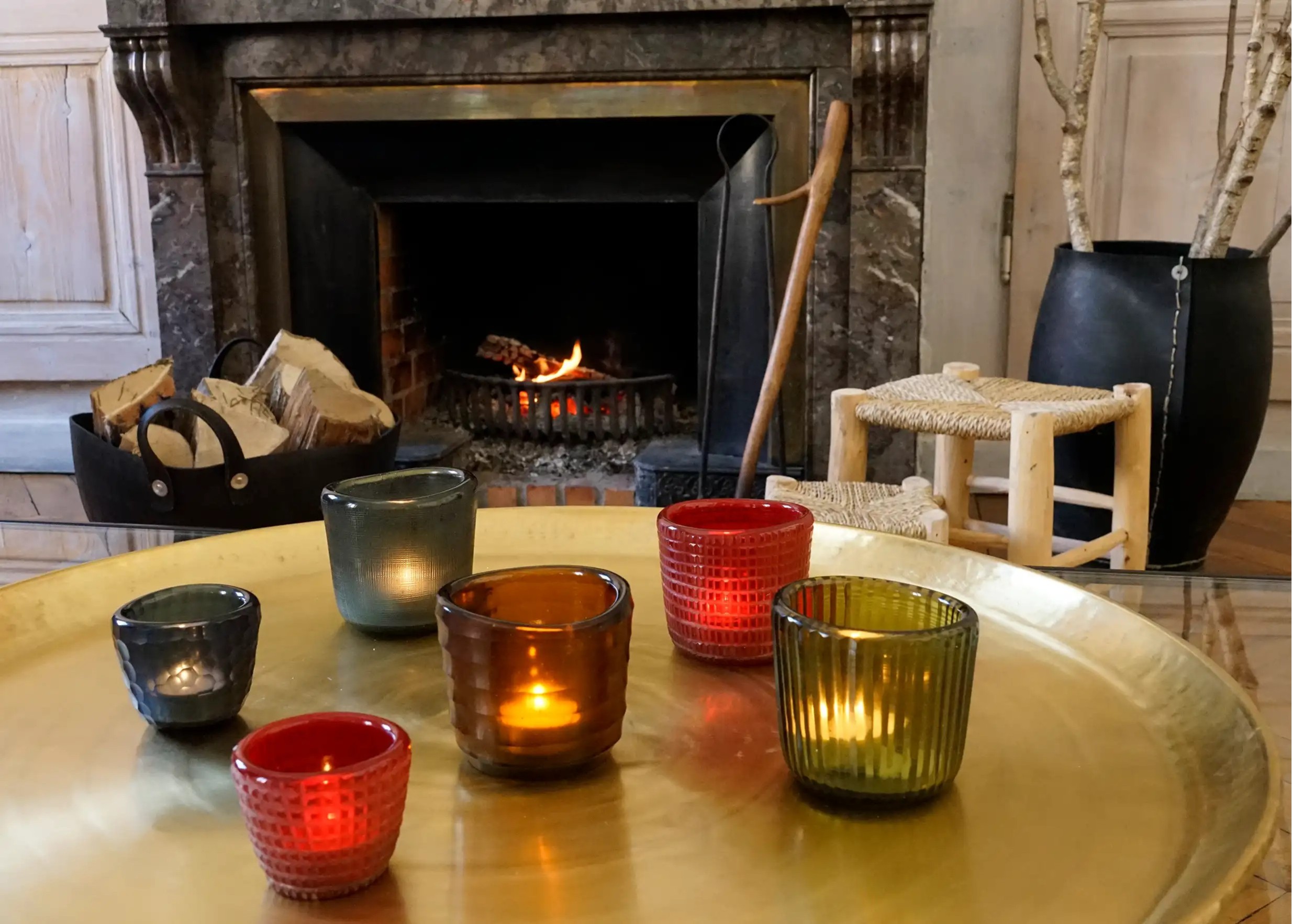 Karawan blown glass tealight holders in different colors on a golden brass tray, living room decor
