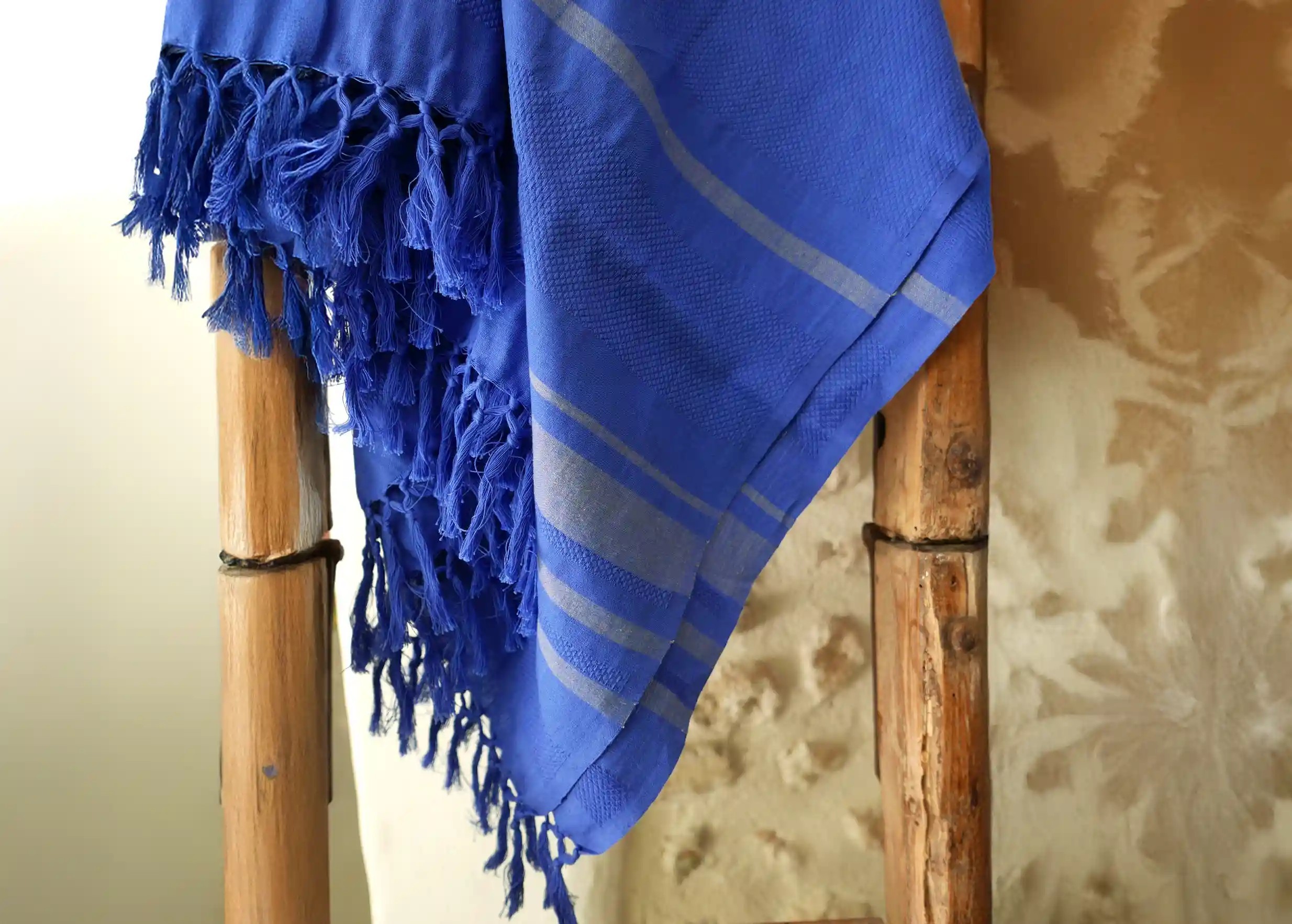 Fouta in Garden organic cotton with honeycomb weave against wooden ladder, stone wall