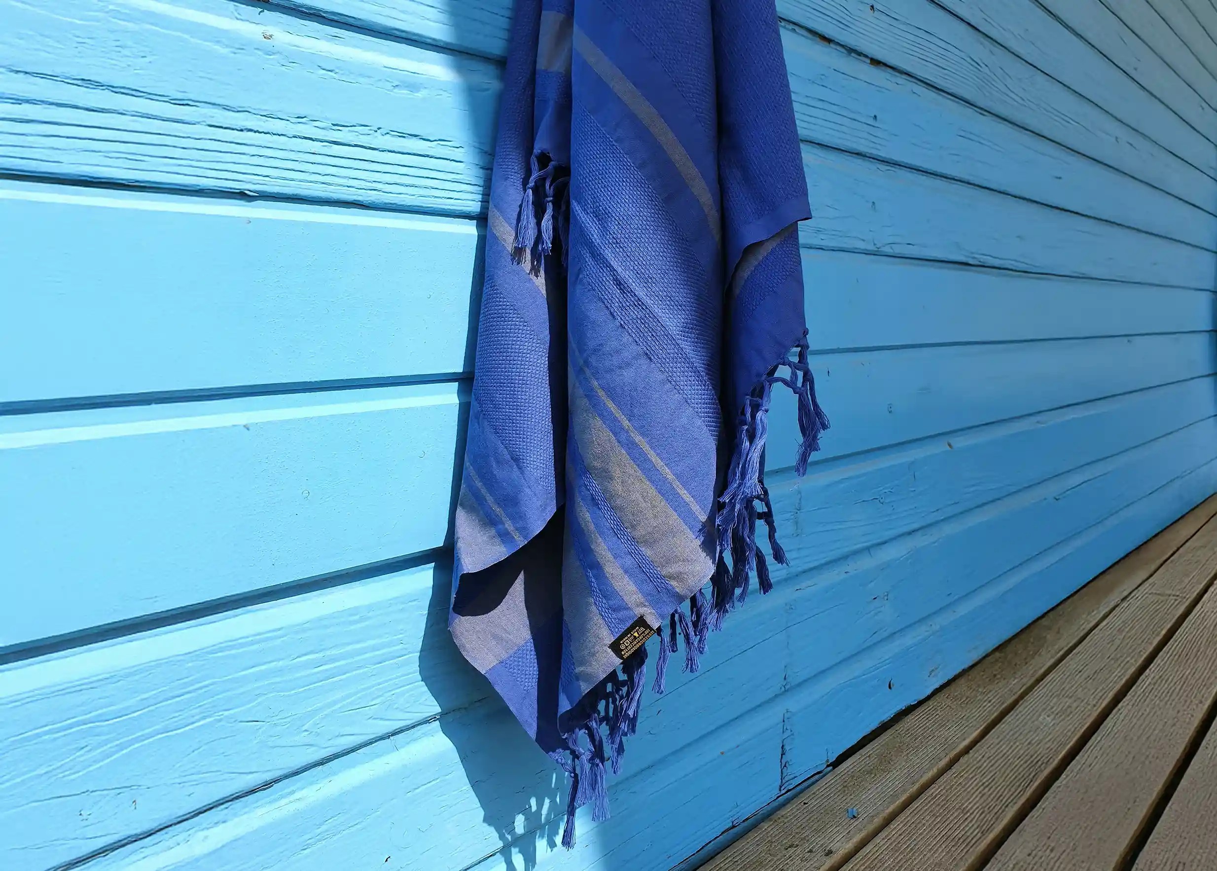 Foutas in organic cotton Garden colour blueberry by Karawan authentic, against a wooden wall