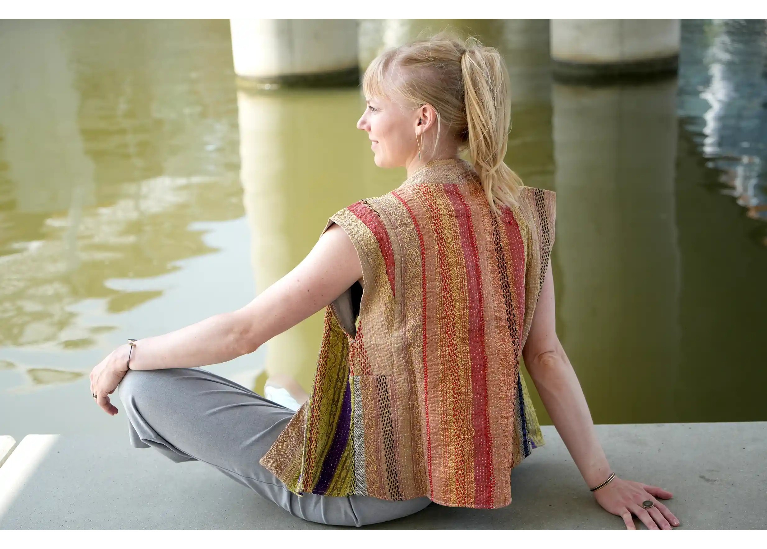 Woman seated by a stream, wearing a quilted cotton kimono