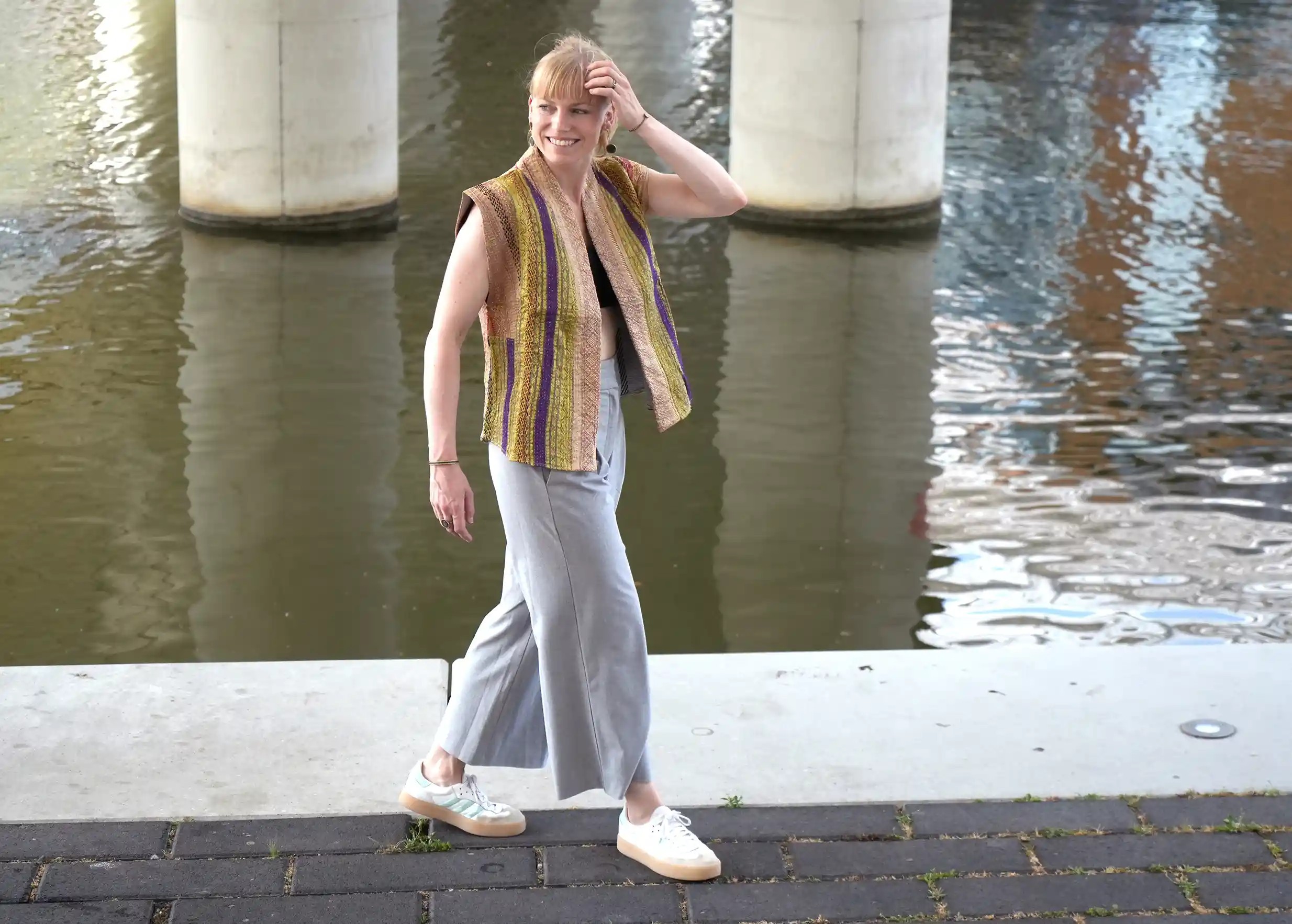 Woman near a stream wearing a unisex quilted cotton kimono jacket by Karawan.