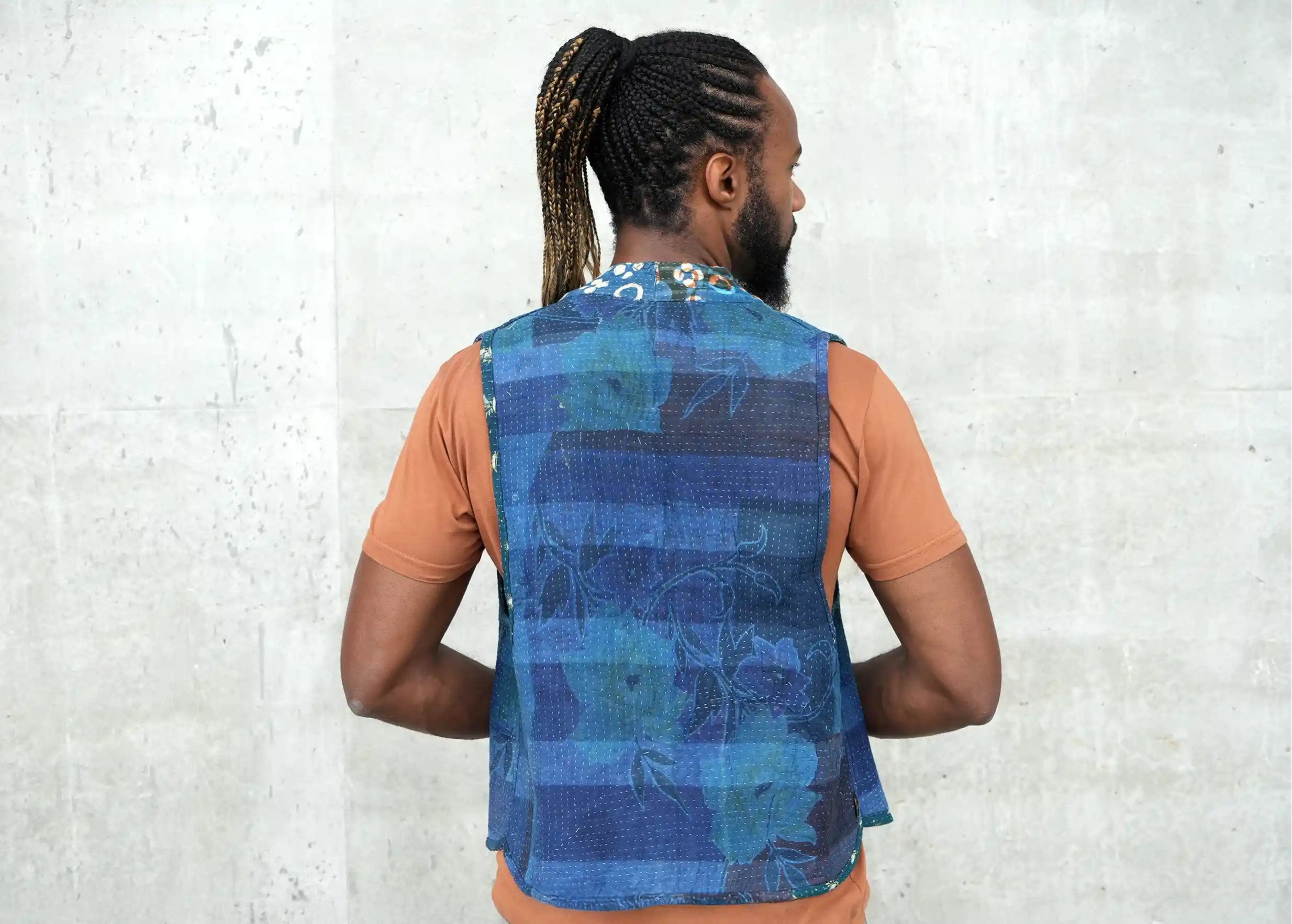 Man from the back wearing a sand t-shirt and a quilted cotton kanta bolero